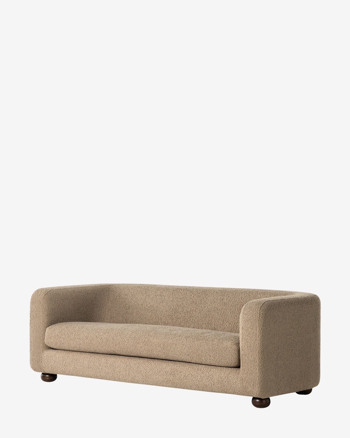The Quill Sofa 84 by Four Hands is a modern beige faux shearling sofa with rounded edges, a low profile, and textured upholstery on dark, short, round legs set against a plain white background. McGee & Co.