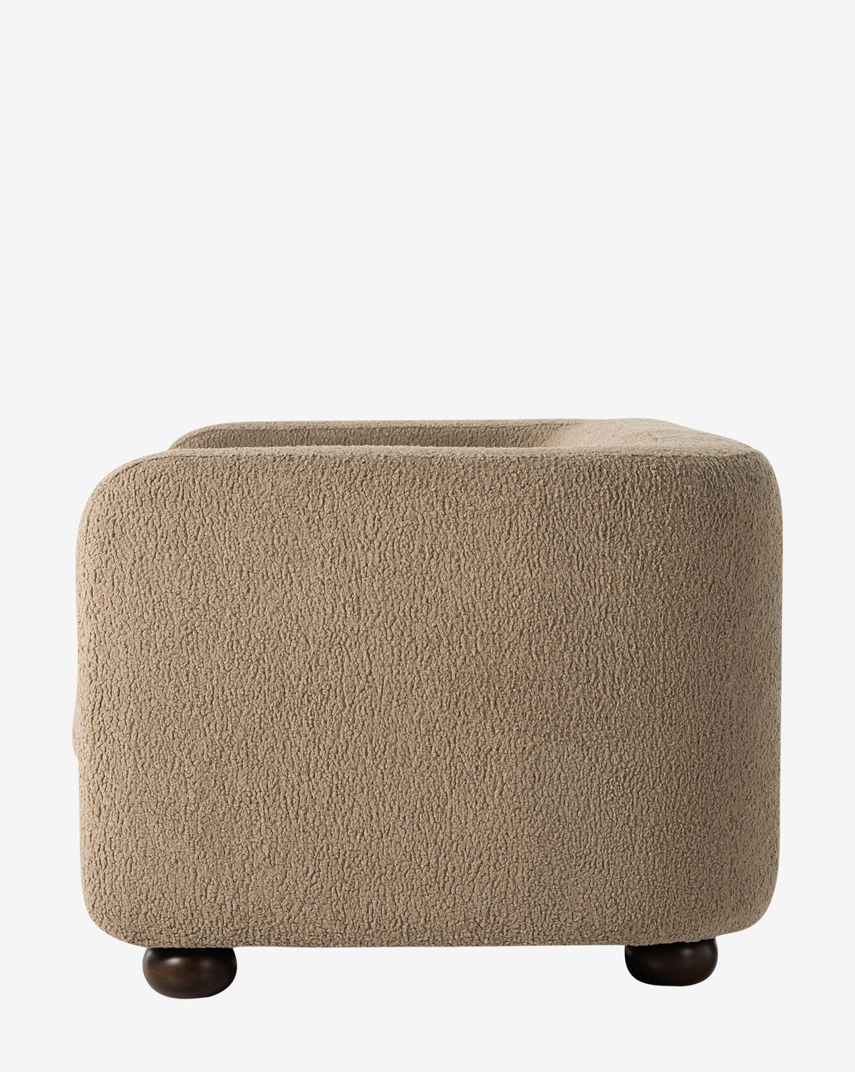 The Four Hands Quill Sofa 84 features a beige, textured finish with rounded edges and dark circular wooden feet, evoking vintage charm. Shown from the side against a plain white background. McGee & Co.