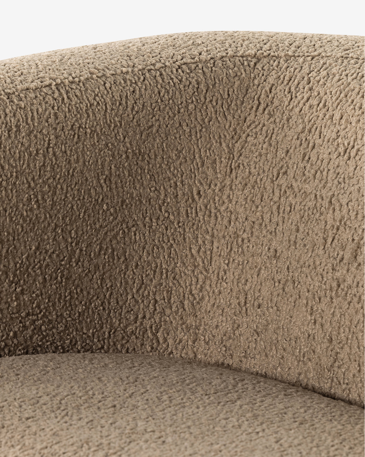 Close-up of the Quill Sofa 84 by Four Hands reveals its textured light brown, woolly upholstery and gently curved backrest, evoking the soft contours of a vintage sofa. McGee & Co.