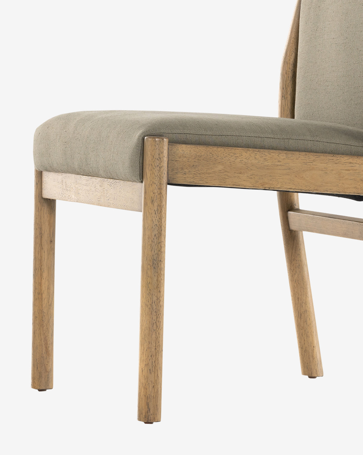 A close-up of the Bardot Dining Chair showcases its light parawood legs and cushioned seat and backrest in high-performance fabric, all set against a white background by McGee & Co.