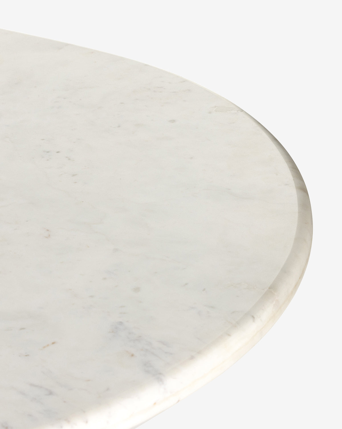 Close-up of the Patrick Dining Table, a round white marble piece with subtle gray veining and a smooth, polished edge, highlighting refined Italian design against a plain white background, by McGee & Co.