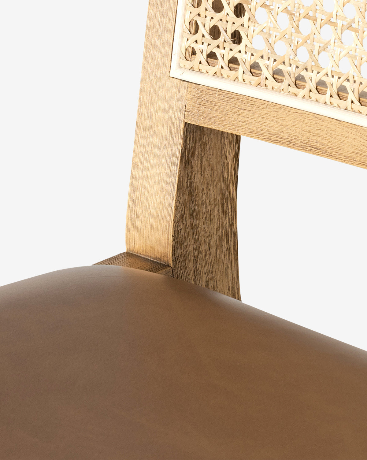The Emeline Stool is shown close-up, highlighting its smooth faux leather cushion, solid beech wood frame, and woven cane backrest against a white background by McGee & Co.