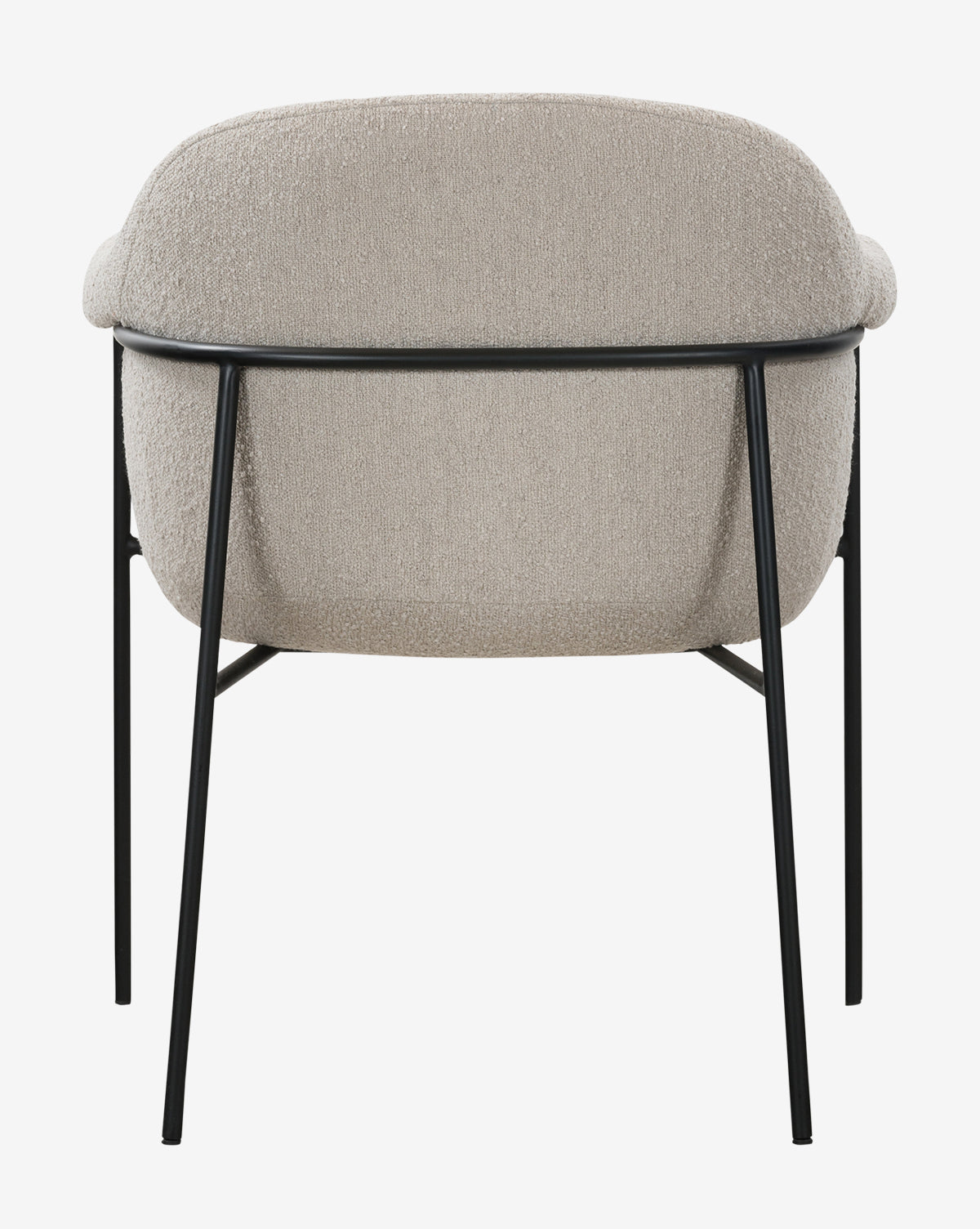 The Sabbath Dining Chair features a rounded, light beige performance fabric seat and backrest, supported by a black metal frame with four slim legs, shown from behind against a plain white background by McGee & Co.