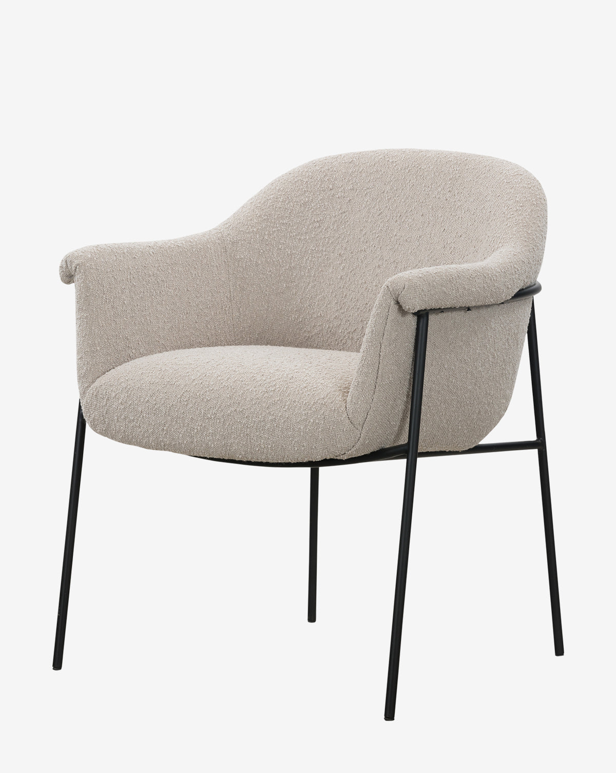The Sabbath Dining Chair features a modern curved back and armrests, upholstered in light beige performance fabric, and stands on slim black metal legs, by McGee & Co.