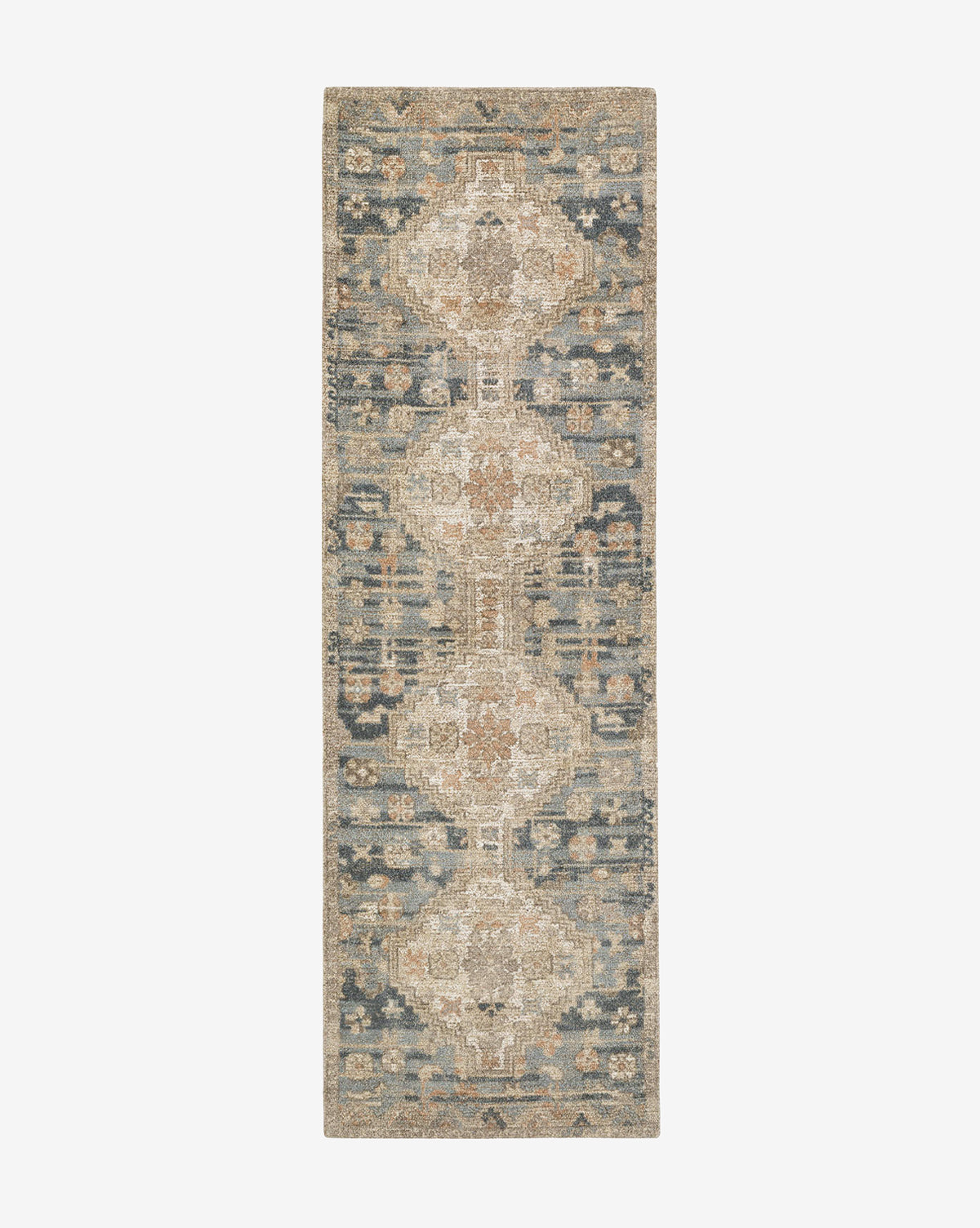 The Wilshire Blue Hand-Tufted Wool Rug is a rectangular, vintage-style runner in a muted blue, beige, and tan palette, featuring intricate geometric and floral patterns with a central medallion design, by McGee & Co.