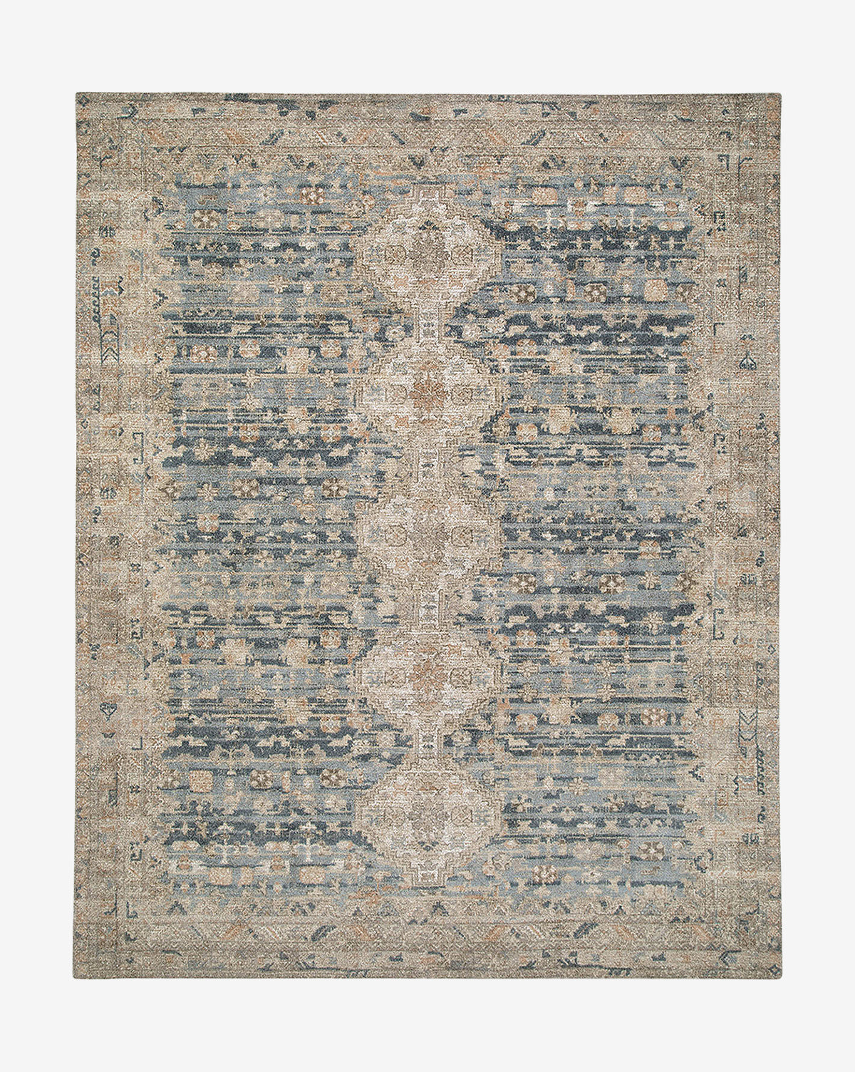 The Wilshire Blue Hand-Tufted Wool Rug features a rectangular shape, distressed vintage-style design in muted blue, beige, and tan, with a central medallion pattern and intricate borders, by McGee & Co.
