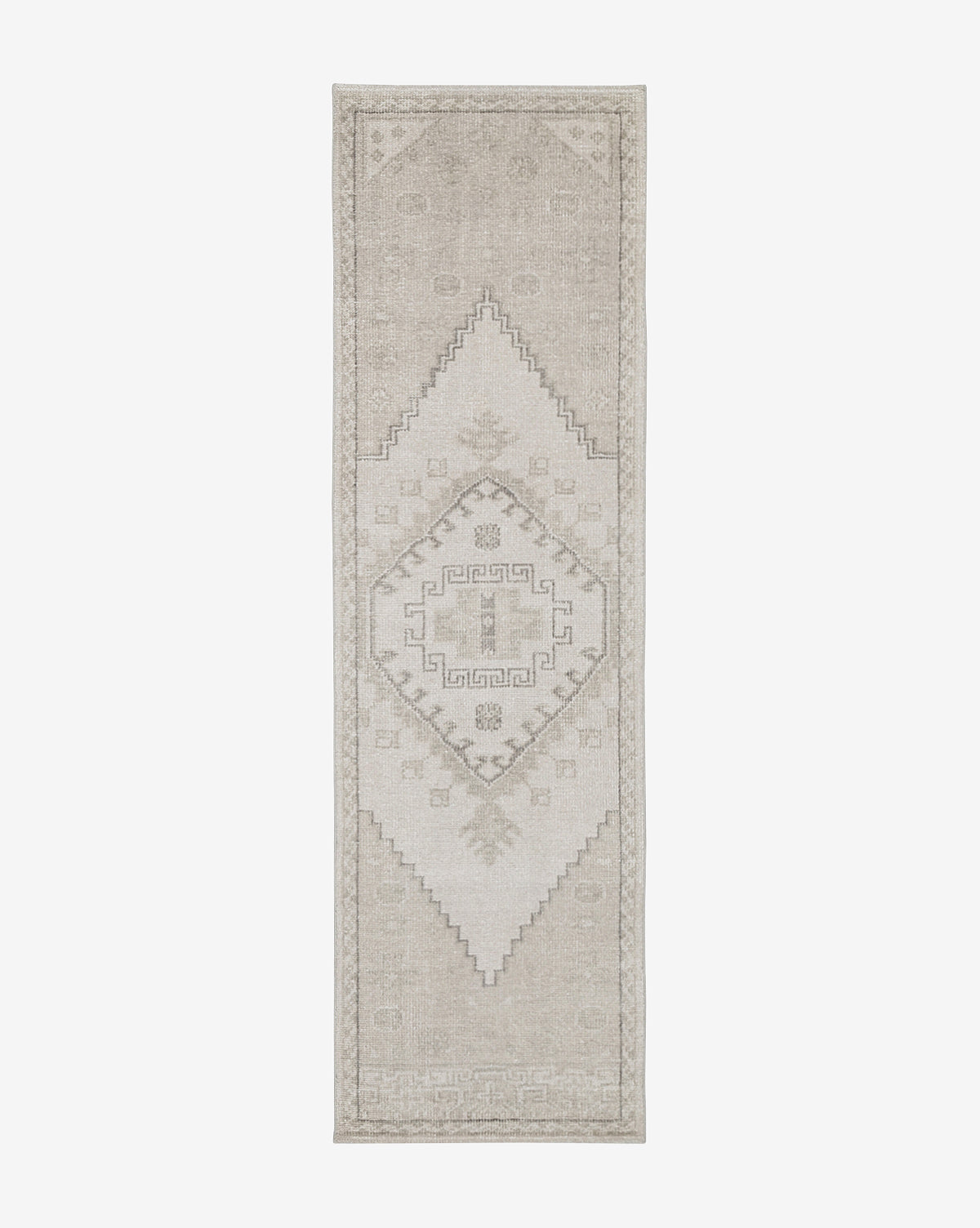 The Pembroke Hand-Knotted Wool Rug is a long, narrow beige runner with subtle geometric diamond patterns and decorative borders, adding timeless vintage-inspired charm and neutral tones to any space, by McGee & Co.
