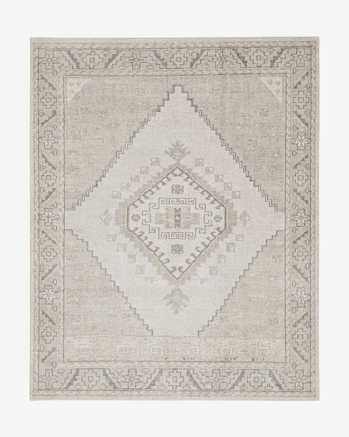 The Pembroke Hand-Knotted Wool Rug showcases a beige and gray vintage-inspired design with a central diamond, geometric motifs, and a detailed border in muted neutral tones, by McGee & Co.
