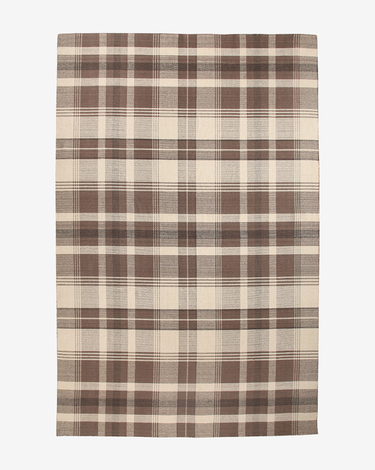 The Orton Handwoven Wool Rug is a rectangular wool rug with a large-scale plaid pattern in brown and beige, featuring intersecting lines for a classic checkered look, by McGee & Co.