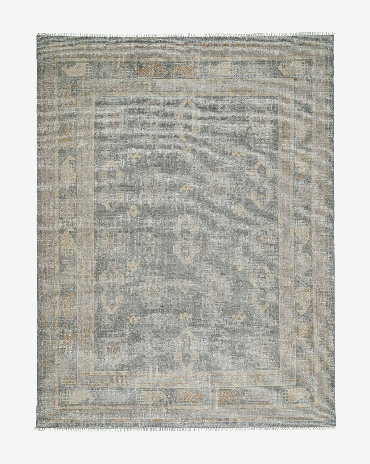 The Roslin Hand-Knotted Wool Rug is a square wool rug with a muted, distressed pattern in soft blue and beige, decorative border, and fringed edges, by McGee & Co.
