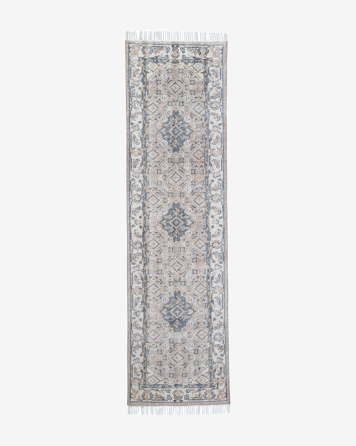 The Merilyn Hand-Knotted Rug is a long, narrow handmade piece with symmetrical, intricate patterns in muted blue and beige tones, complete with a decorative border and fringed edges, by McGee & Co.