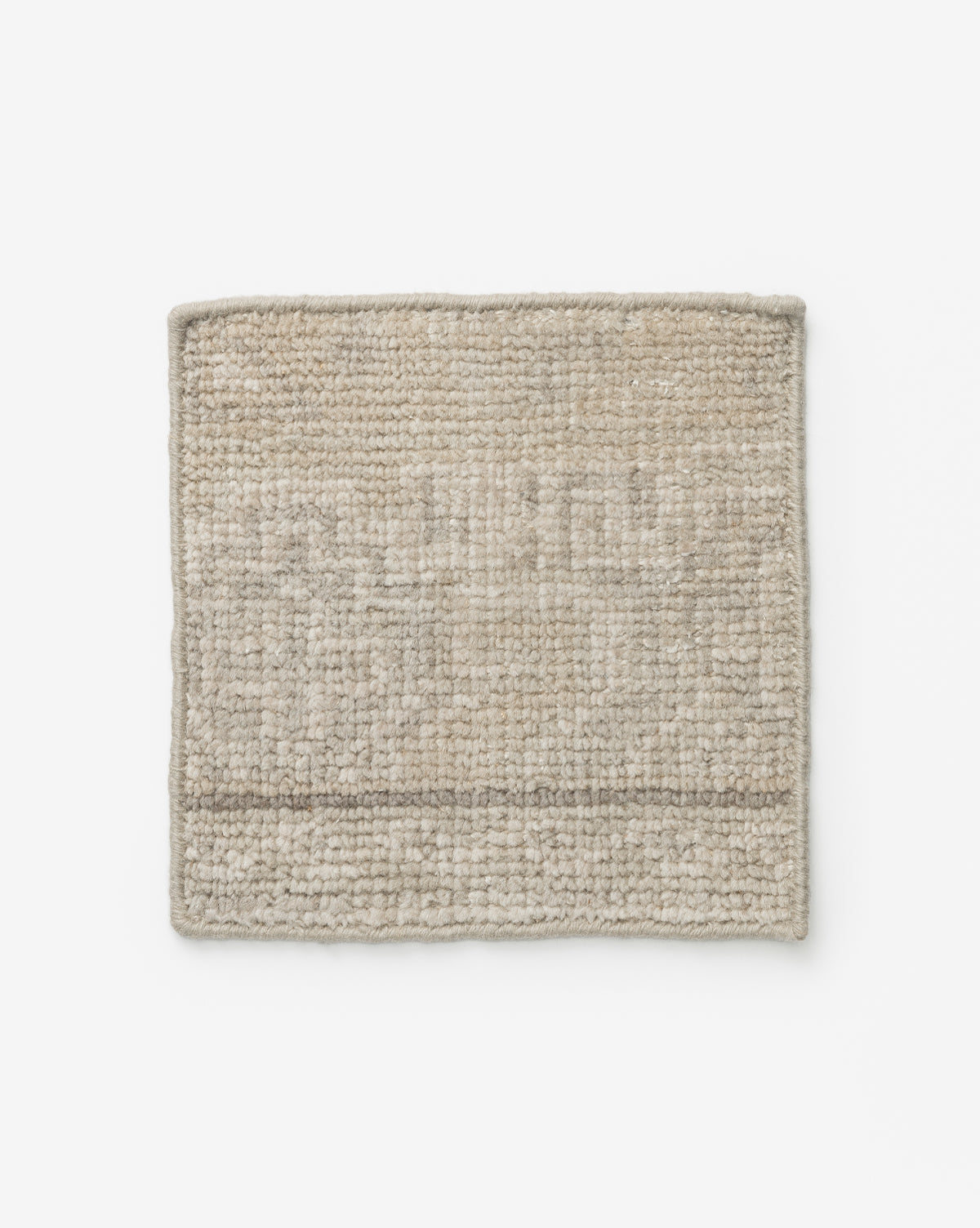 The Pembroke Hand-Knotted Wool Rug Swatch features a square beige textured weave with a subtle pattern and a slightly darker border, showcased against a white background for a vintage-inspired look, by McGee & Co.