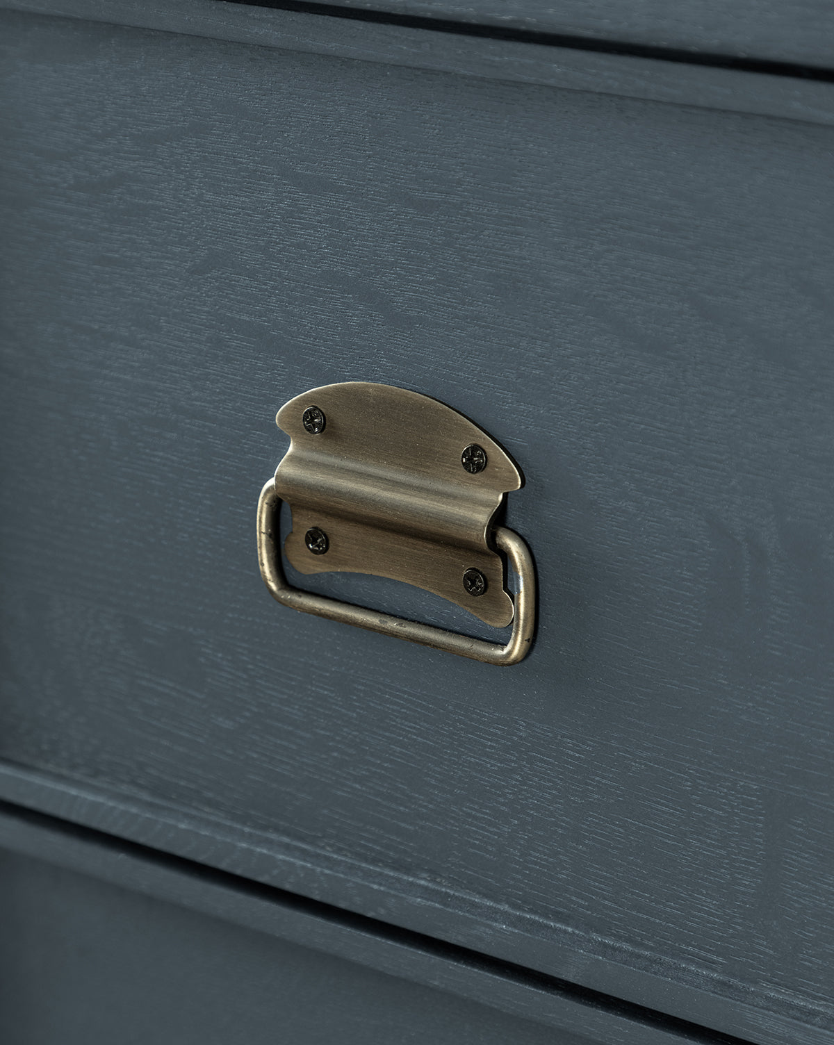 Close-up of a dark gray wood drawer from the Mackenna Dresser, highlighting rectangular brass pulls secured by four screws.