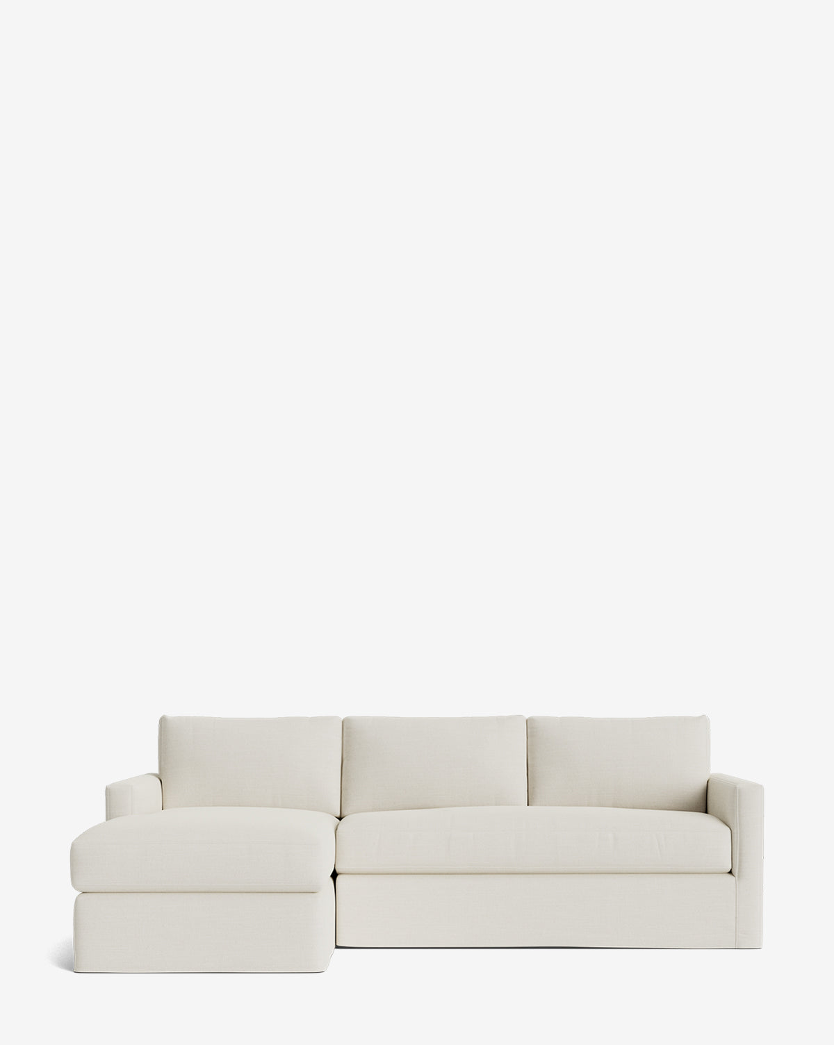 The Community Macy Slipcover Chaise Sectional 101 is a modern, light beige sofa with a left-facing chaise, clean lines, three seat cushions, and three back cushions, shown against a plain white background. McGee & Co.