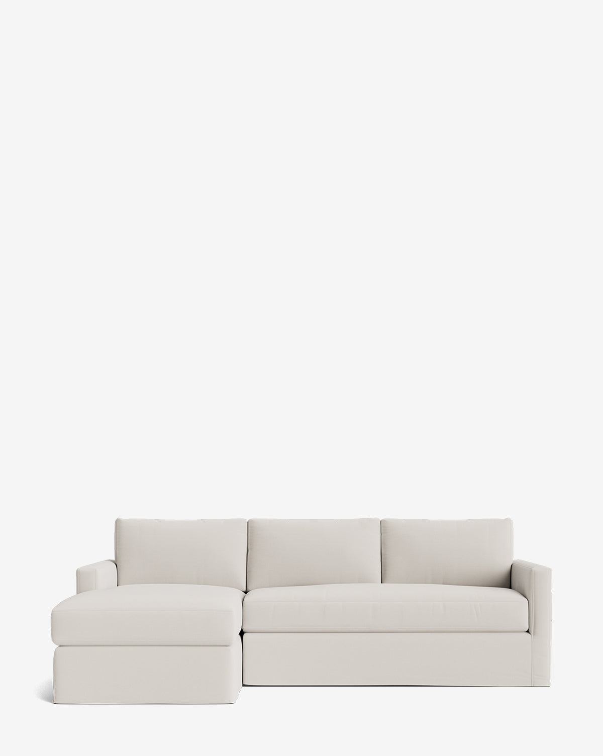 The Community Macy Slipcover Chaise Sectional 101 features a modern, light beige design with three back cushions and a left-facing chaise—customizable for versatile comfort, shown against a plain white background. McGee & Co.