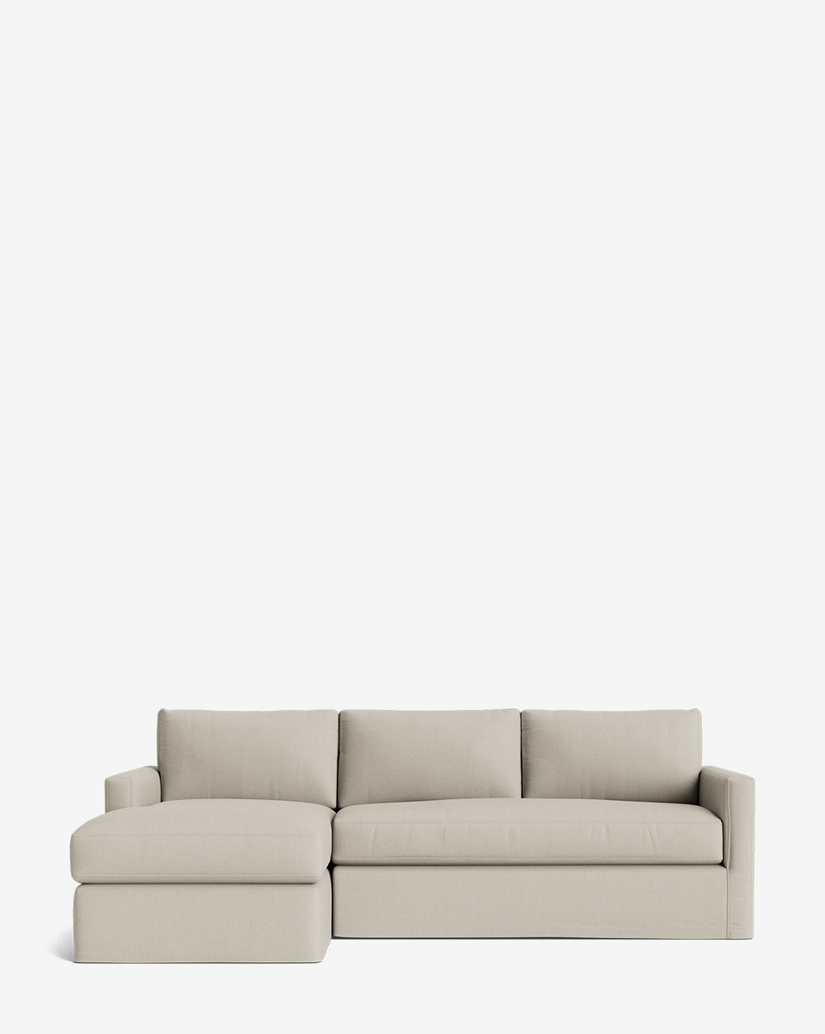 The Macy Slipcover Chaise Sectional 101 is a modern, light beige customizable sofa with a left-side chaise, featuring clean lines and three back cushions, displayed against a plain white background by McGee & Co.