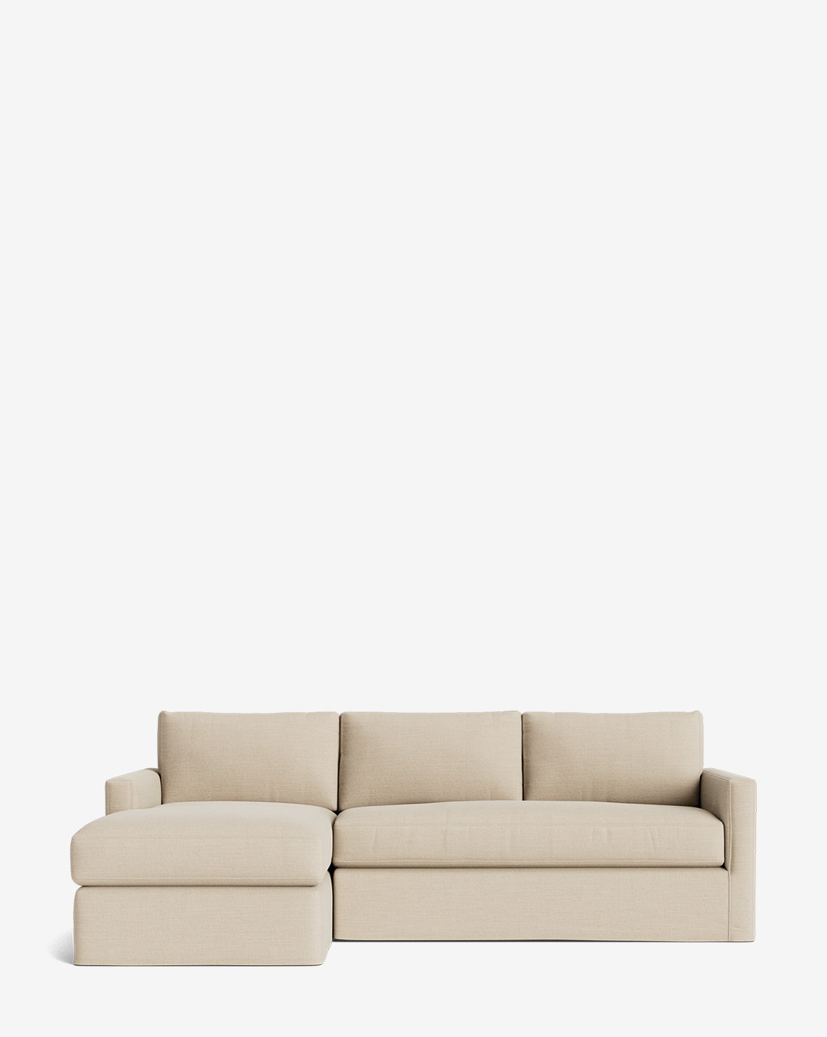 The Macy Slipcover Chaise Sectional 101 by Community features three seat and back cushions, a left-side chaise, and a deep-sectional design in beige, shown against a plain white background by McGee & Co.
