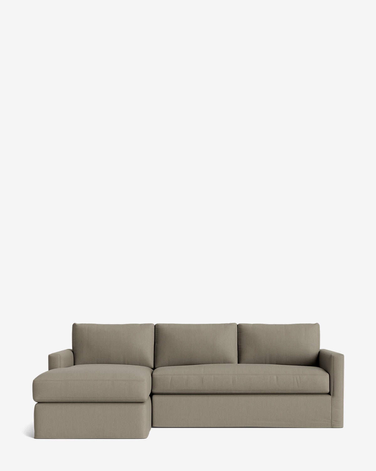 The Macy Slipcover Chaise Sectional 101 is a modern, customizable light gray sofa featuring three seat and back cushions, plus a deep left-side chaise lounge, all set against a plain white background by McGee & Co.