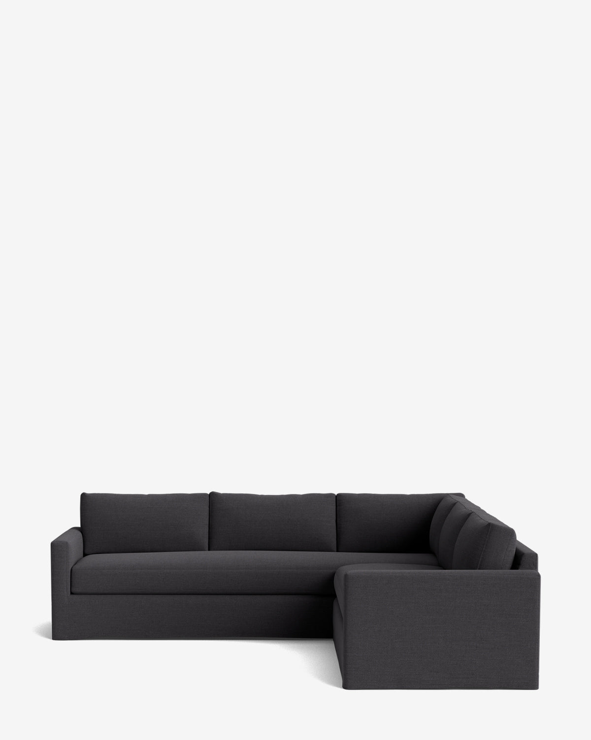 A modern Macy Slipcover L Sectional 108 in dark gray, with clean lines and low backrests, features a deep silhouette against a plain white background, by McGee & Co.