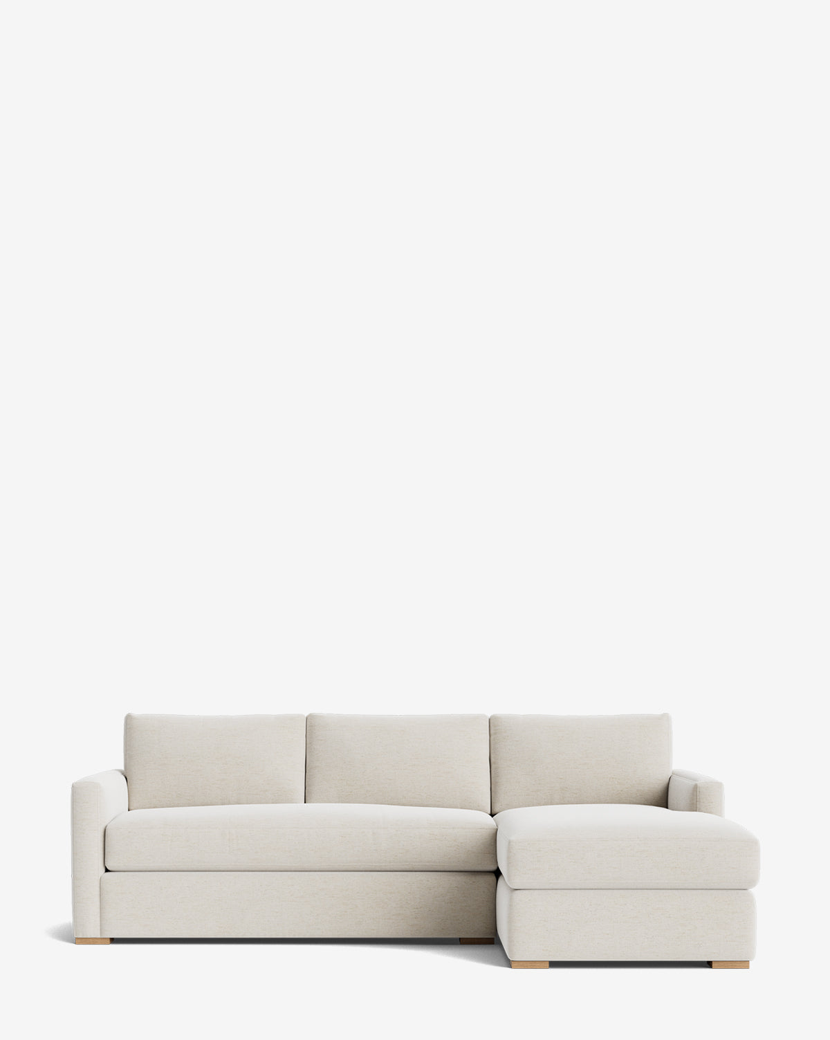 The Macy Upholstered Chaise Sectional 101 is a modern, light beige sofa with three seat cushions, a right-hand upholstered chaise, low square arms, and wooden block feet, shown against a plain white background by McGee & Co.