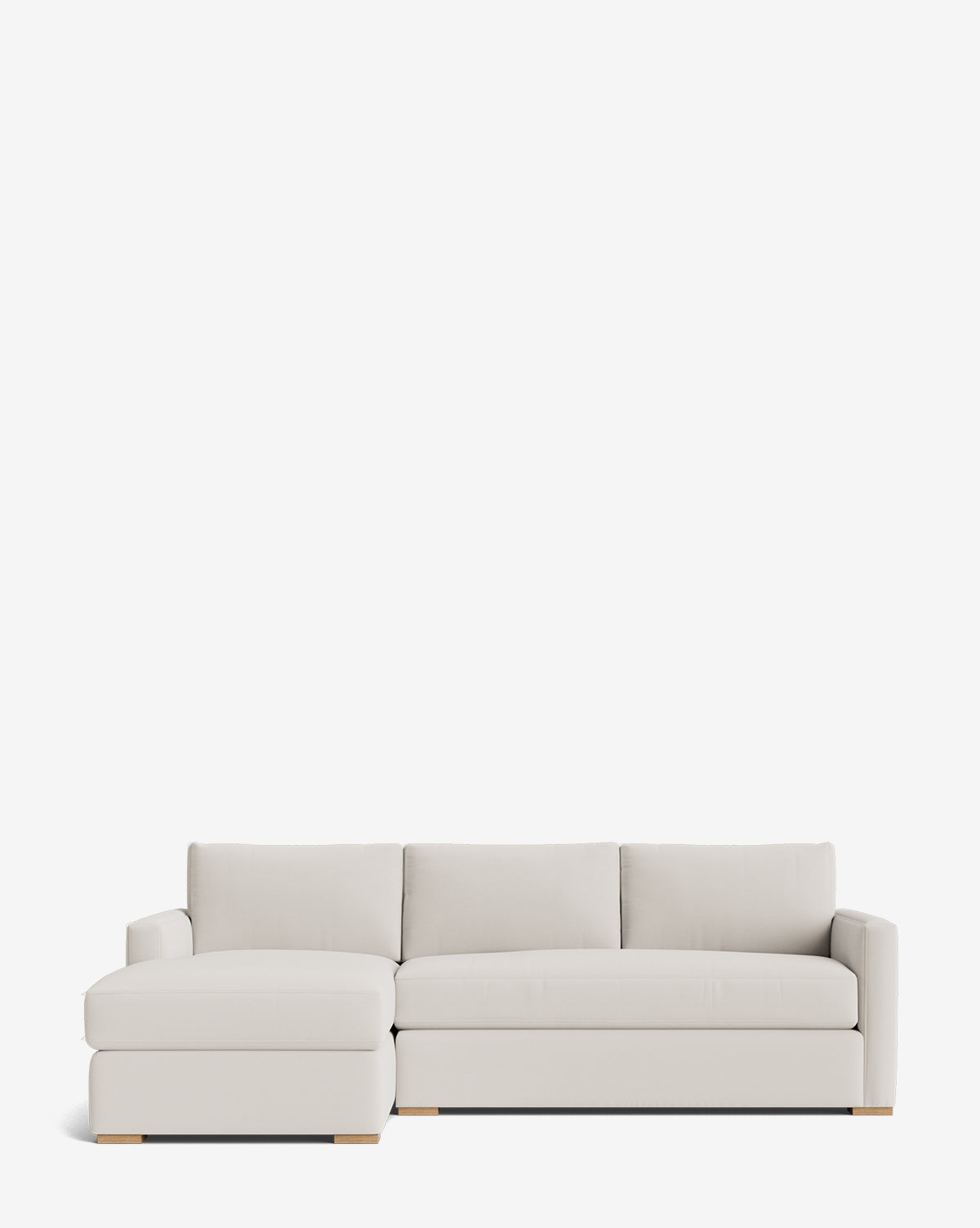 The Macy Upholstered Chaise Sectional 101 is a modern, light gray sofa with a left-facing chaise, three seat and back cushions, and low wooden block feet, shown against a white background by McGee & Co.