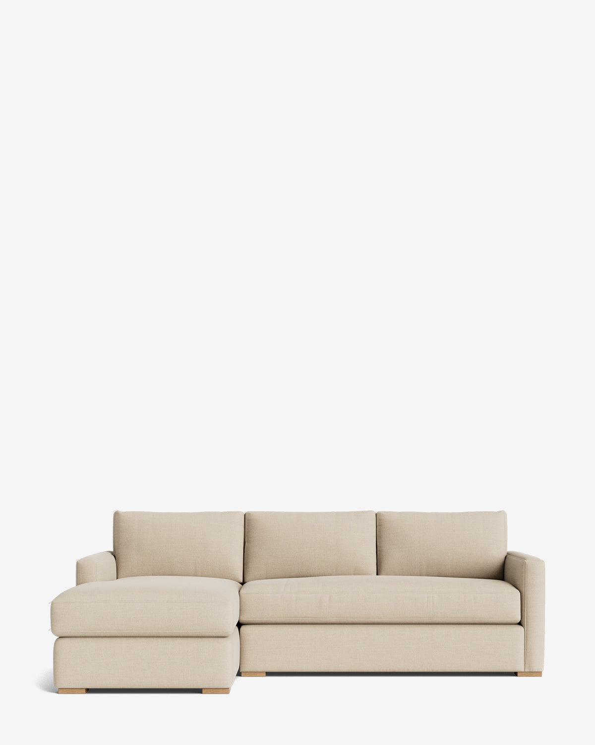 The Community Macy Upholstered Chaise Sectional 101 is a modern, minimalist sofa with a left-facing chaise, three seat cushions, three back cushions, and low wooden legs, shown set against a plain white background. McGee & Co.