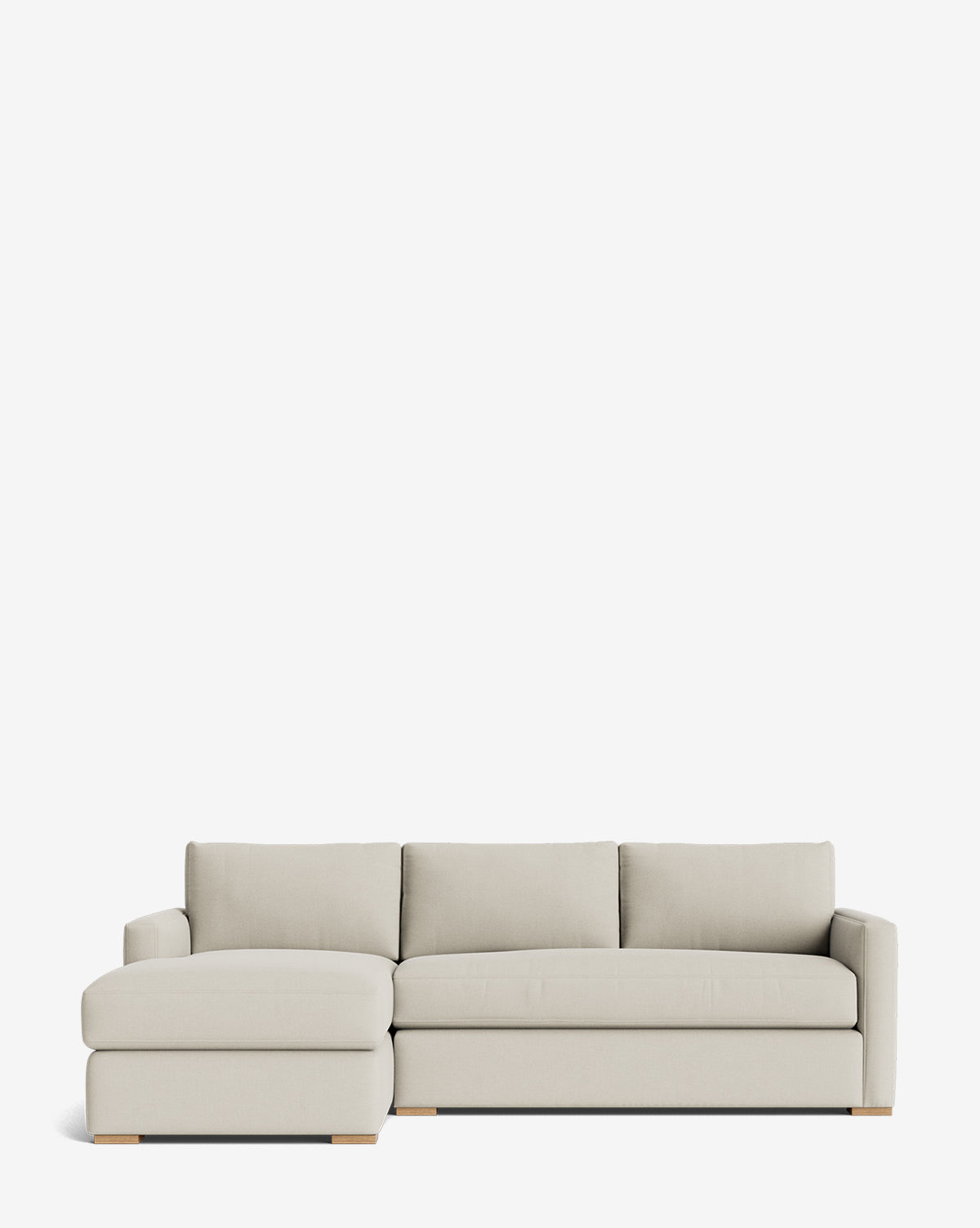 The Macy Upholstered Chaise Sectional 101 is a modern, light beige sofa with clean lines, low wooden legs, and a left-facing chaise, shown against a plain white background by McGee & Co.