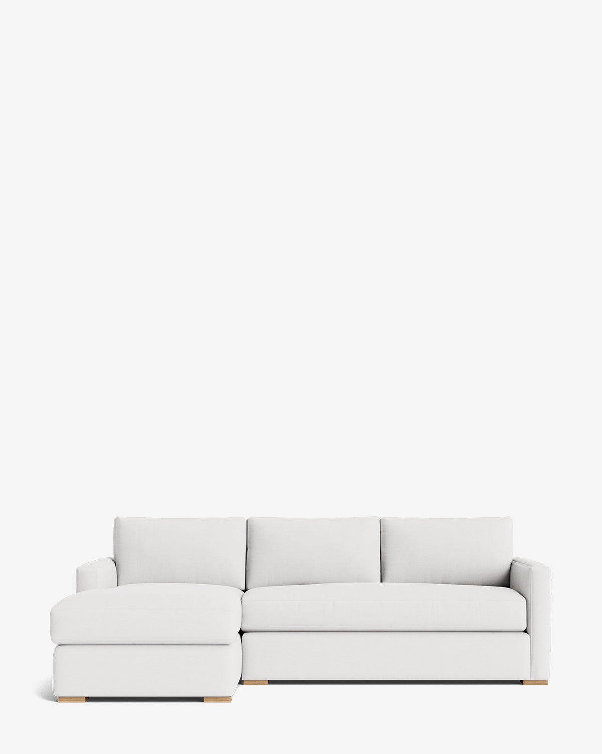 The Macy Upholstered Chaise Sectional 101 features a modern white design with a left-facing upholstered chaise, clean lines, and light wooden legs, shown against a plain white background by McGee & Co.
