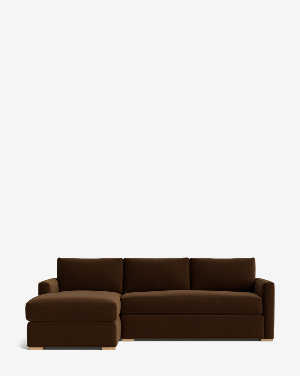 The Community Macy Upholstered Chaise Sectional 101 features three back cushions and a left-side chaise lounge, all set on light wooden legs and photographed against a plain white background. McGee & Co.