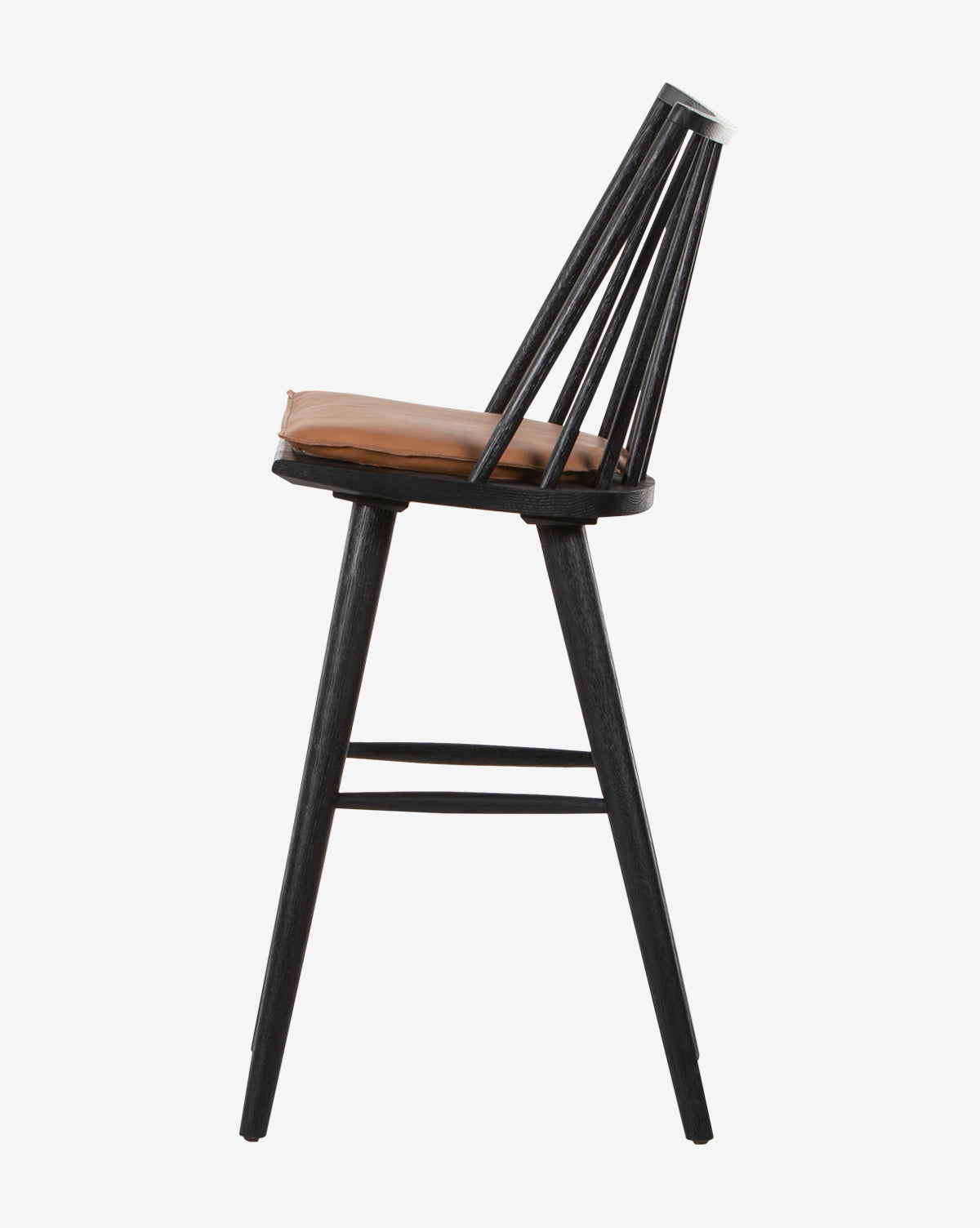 Side view of the Madison Stool, featuring a modern black wooden frame, round light brown cushioned seat, and angled spindle backrest, set against a plain white background.