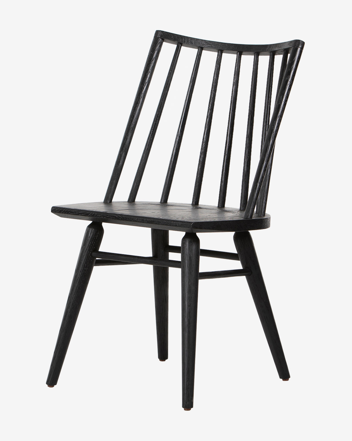 The Madison Dining Chair is a black Windsor-style seat with a slightly angled backrest, vertical slats, and four tapered legs, displayed against a plain white background by McGee & Co.