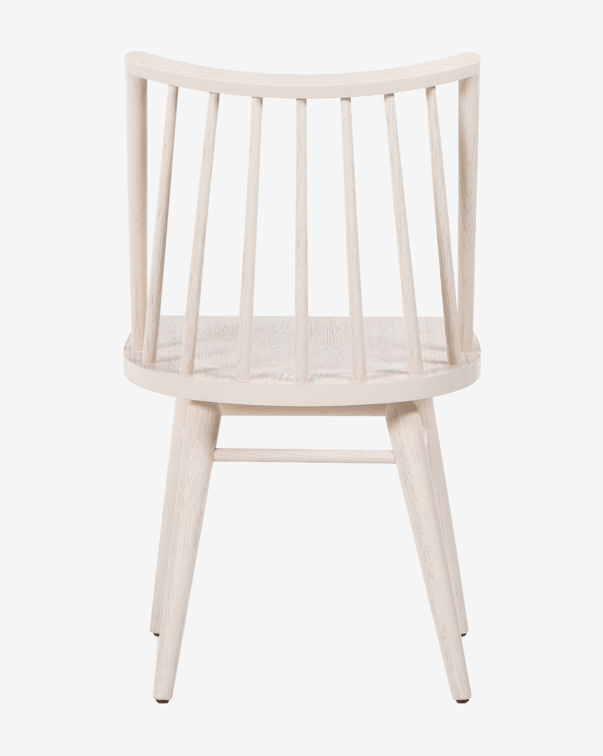 The Madison Dining Chair, crafted from light oak, showcases a contemporary Windsor design with a curved backrest, vertical slats, and four angled legs, seen from behind against a white background by McGee & Co.
