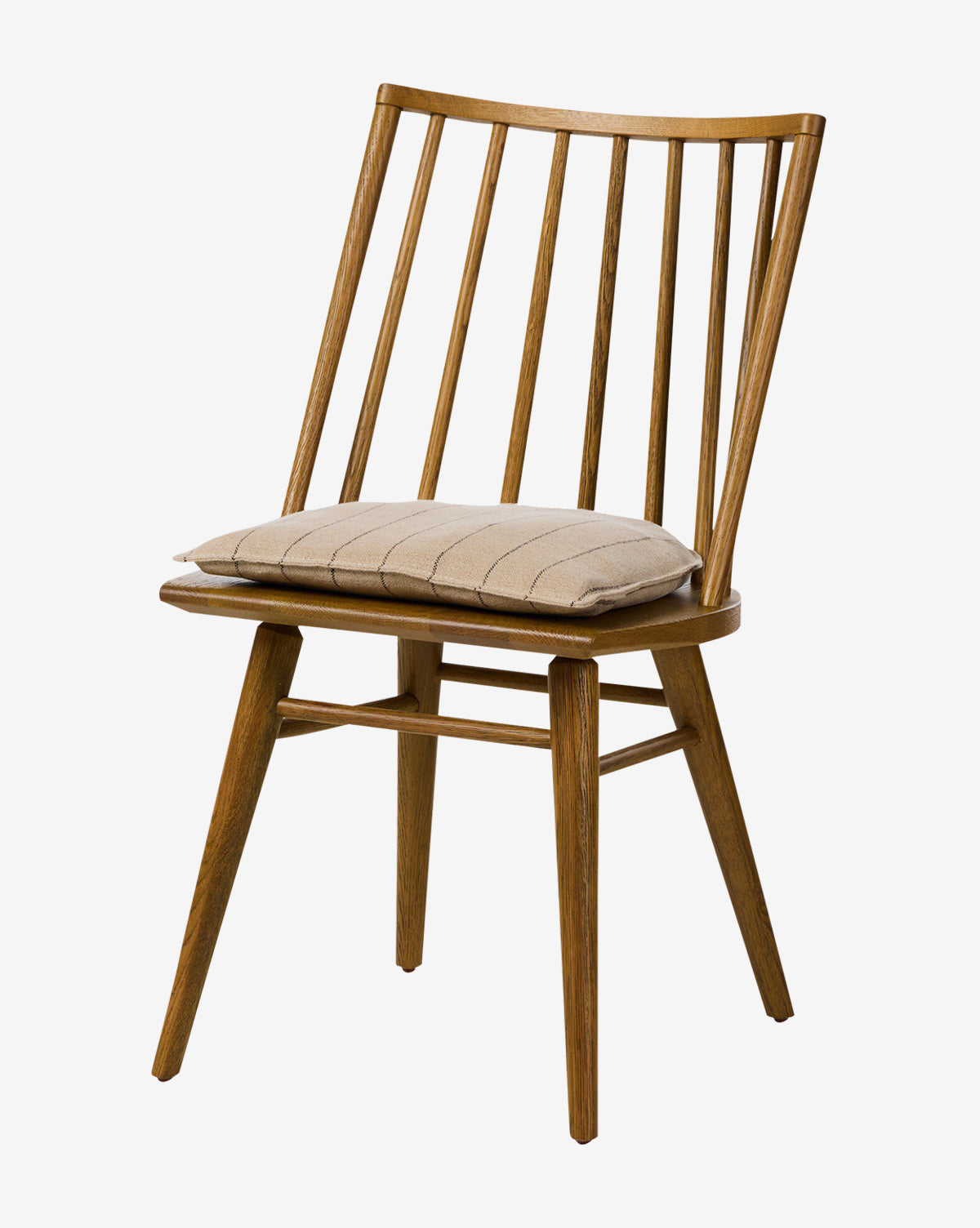 The Madison Dining Chair features a contemporary oak frame with a slatted backrest, angled legs, and a beige seat cushion, shown against a plain white background by McGee & Co.