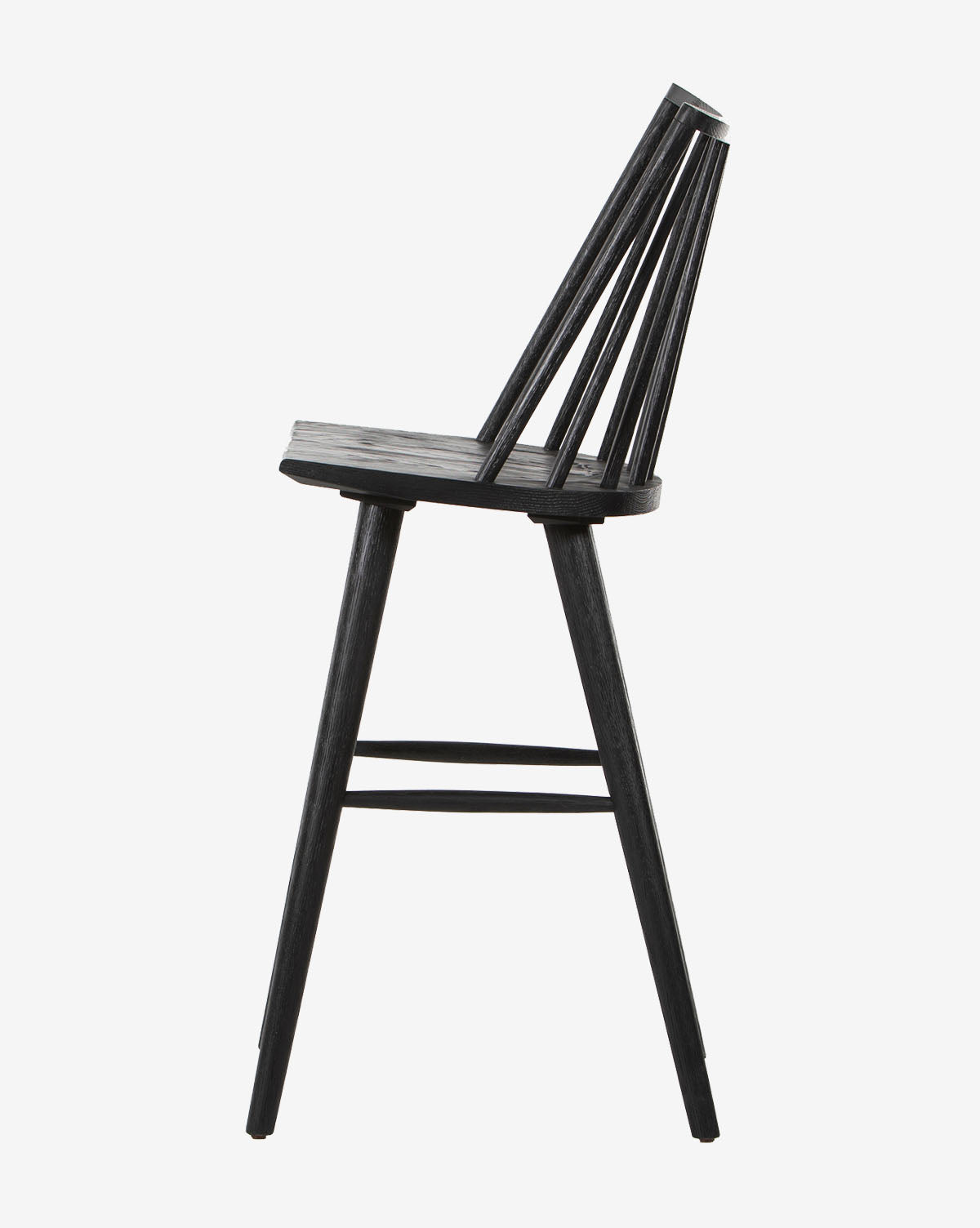 Side view of the Madison Stool, a modern black wooden seat featuring a slatted backrest, angled back legs, and a slightly curved seat, set against a plain white background.