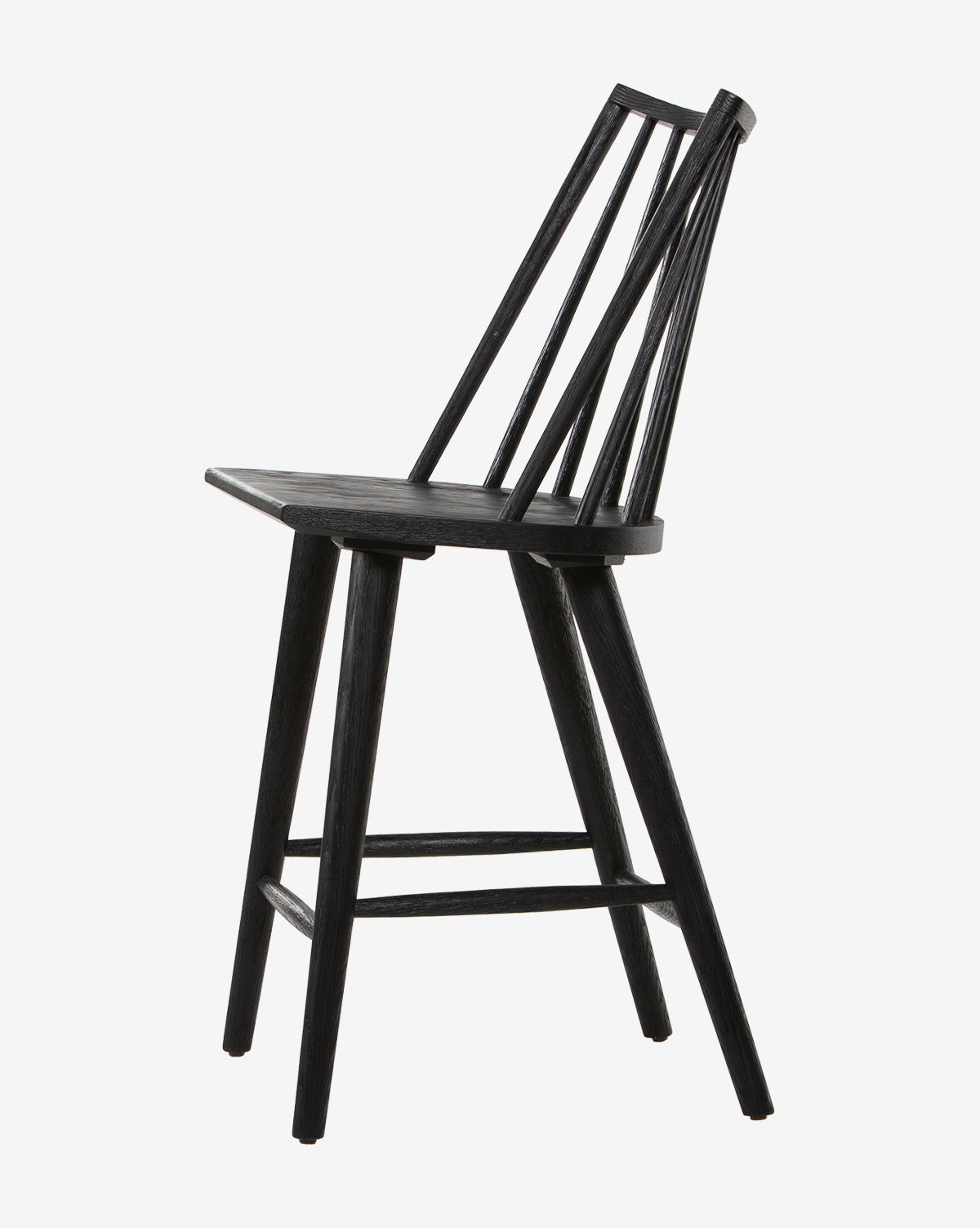 A side view of the Madison Stool in black wood, featuring a slanted backrest with four angled spindles, a flat seat, and four legs connected by crossbars, displayed against a white background.