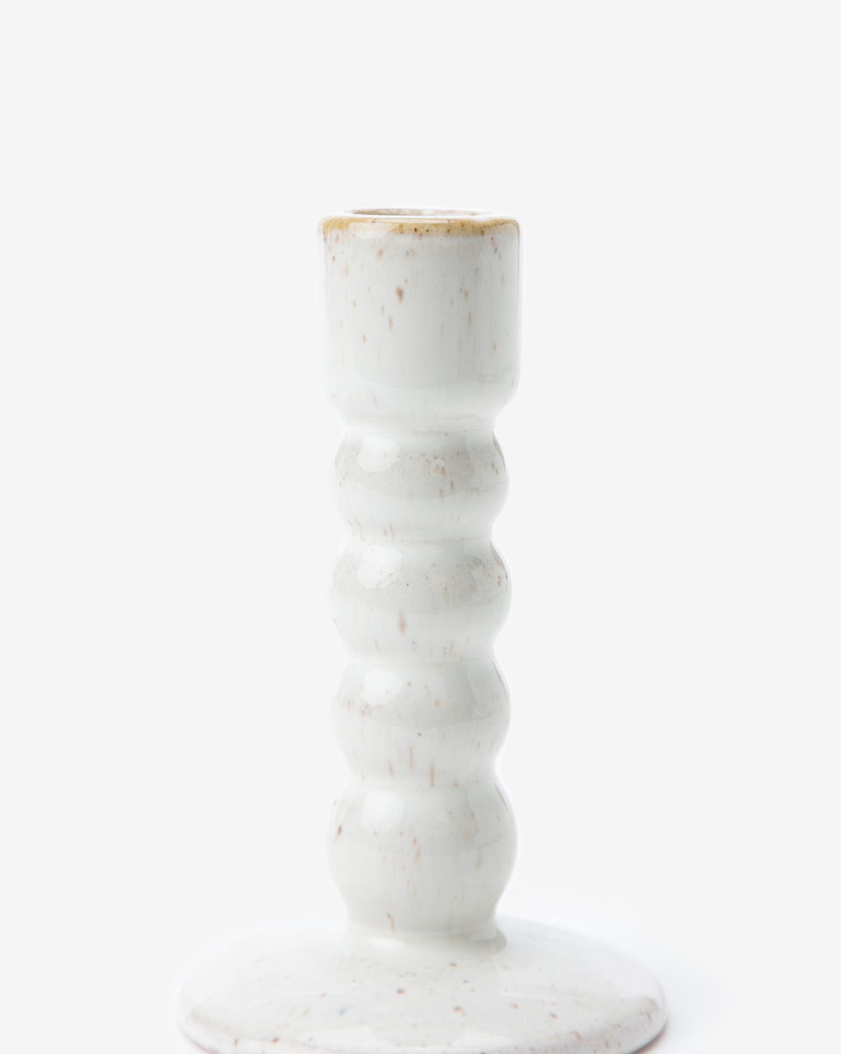The Mae Ceramic Taper Holder features a white glazed stoneware design with a textured, wavy stem and round base, shown on a plain white background.