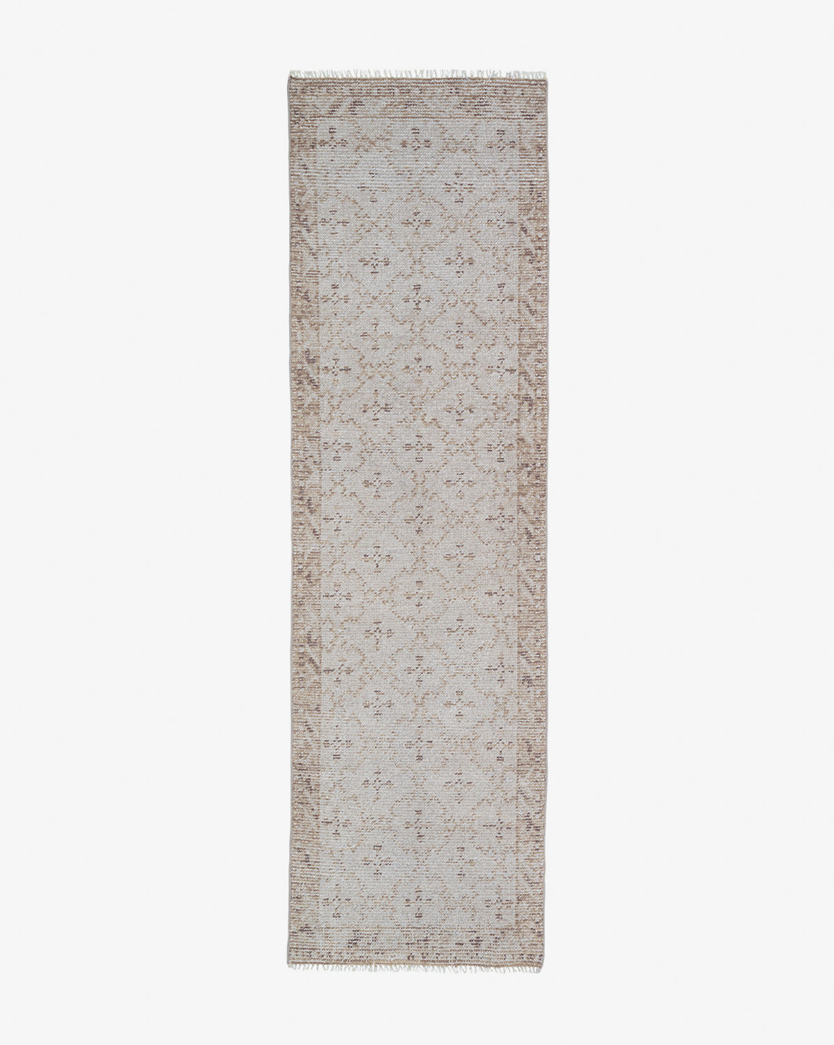 The Mali Hand-Knotted Rug is a rectangular, beige rug with an intricate floral pattern and fringed edges, shown on a white background—a versatile neutral accent for any room, by McGee & Co.