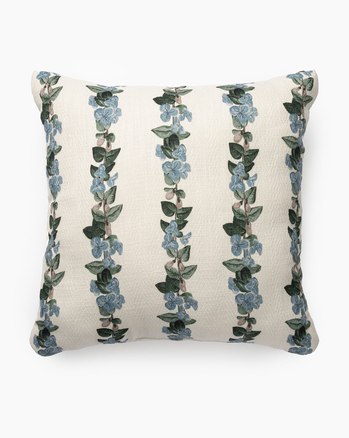 The Malyn Indoor/Outdoor Pillow features a white background with weather-resistant fabric and vertical stripes of green leaves and blue flowers in a repeating floral motif, by McGee & Co.
