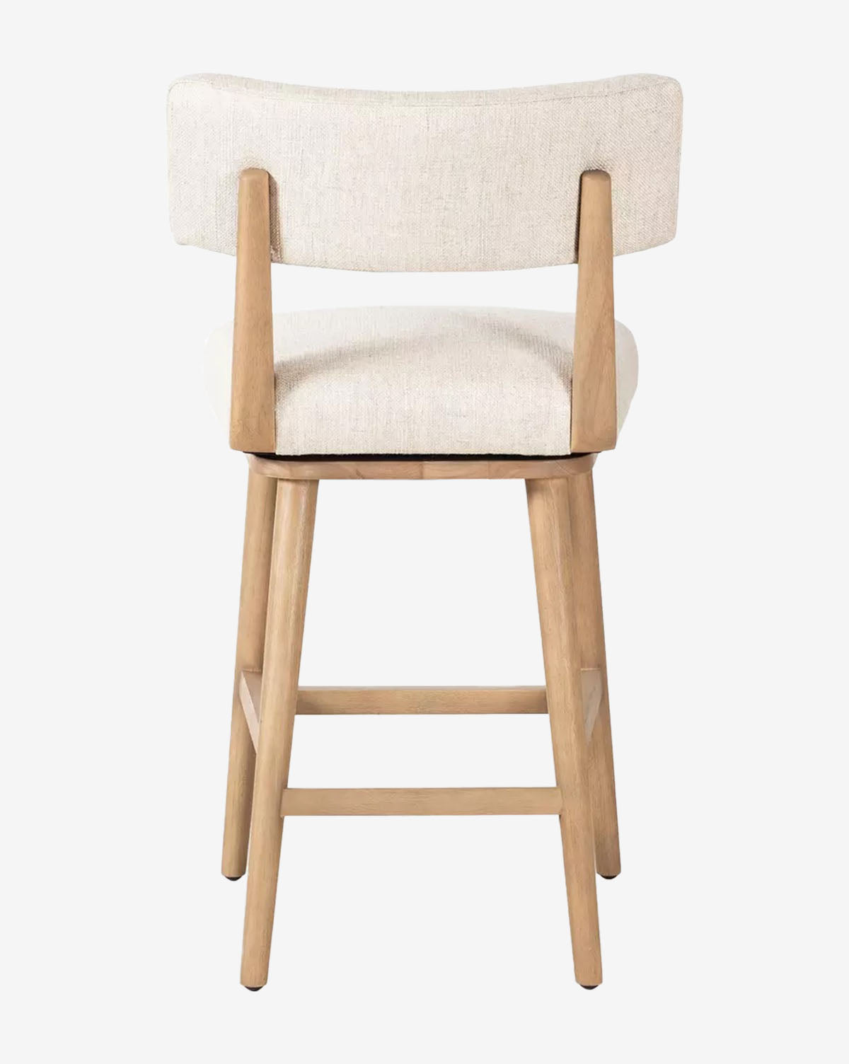 The Mance Swivel Stool by Four Hands features a wooden frame, upholstered seat, and light beige backrest, shown from the back against a white background. Its four legs with horizontal supports make it ideal for any kitchen. McGee & Co.