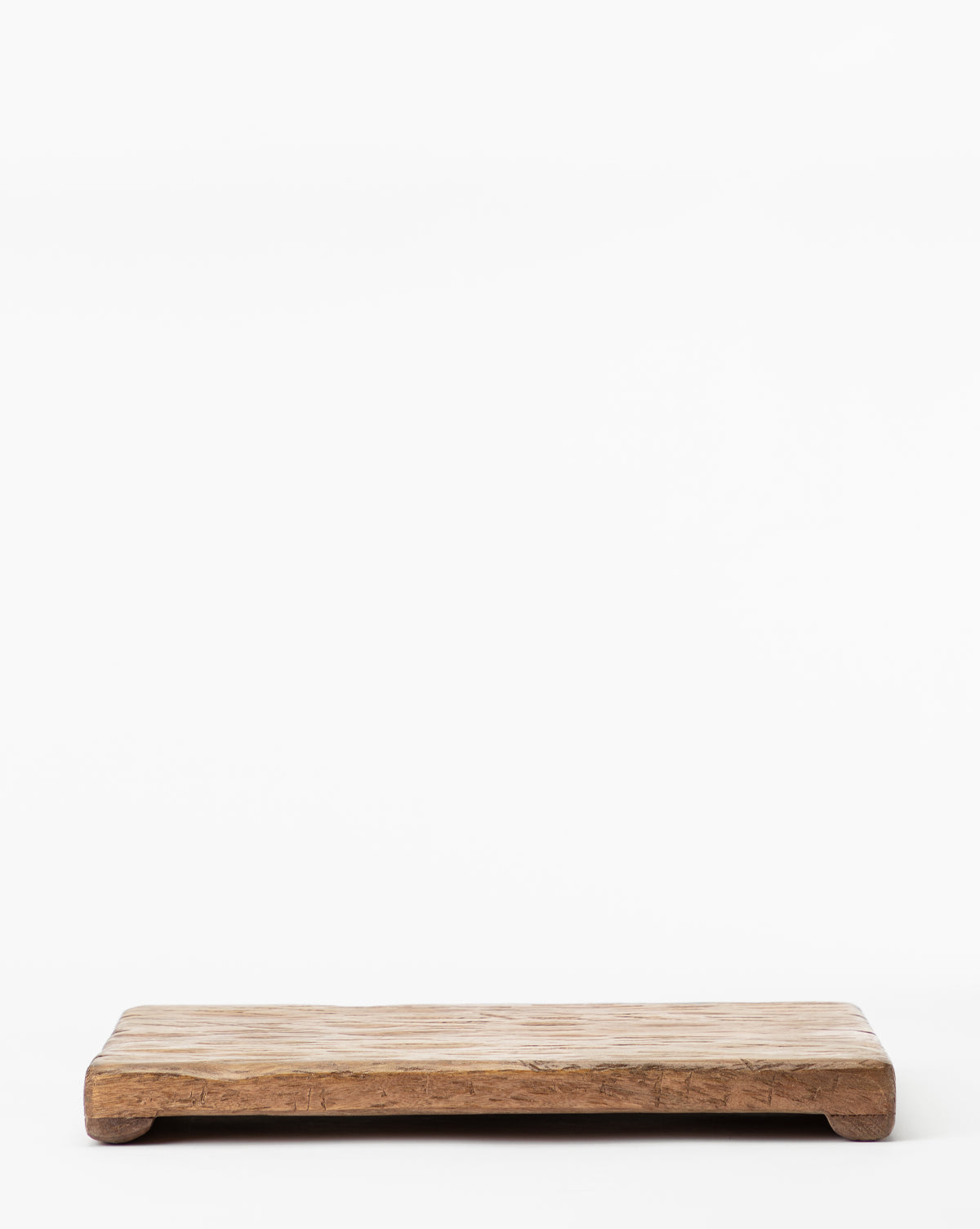 A rustic Mango Wood Rectangular Pedestal with a natural finish and visible grain patterns rests on a white background, showcasing slight wear for a vintage, handcrafted look.