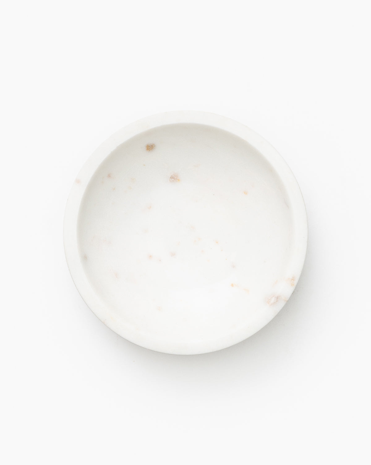 The Marble Nesting Bowls (Set of 3) feature small, round, shallow white marble dishes with natural brownish specks—ideal for display alone or nesting together. Shown on a plain white background.