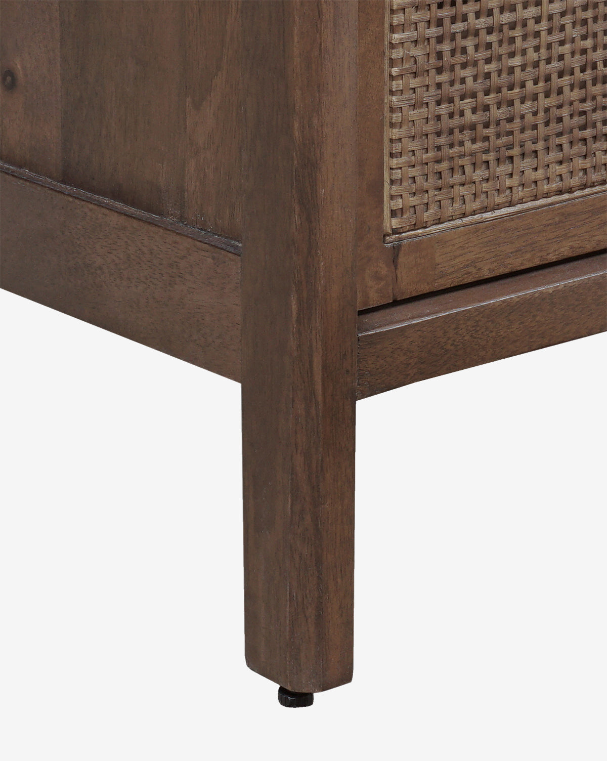Close-up of the Margaery Nightstands bottom corner, featuring a mango wood frame, woven rattan panel, and straight wooden legs against a white background, by McGee & Co.