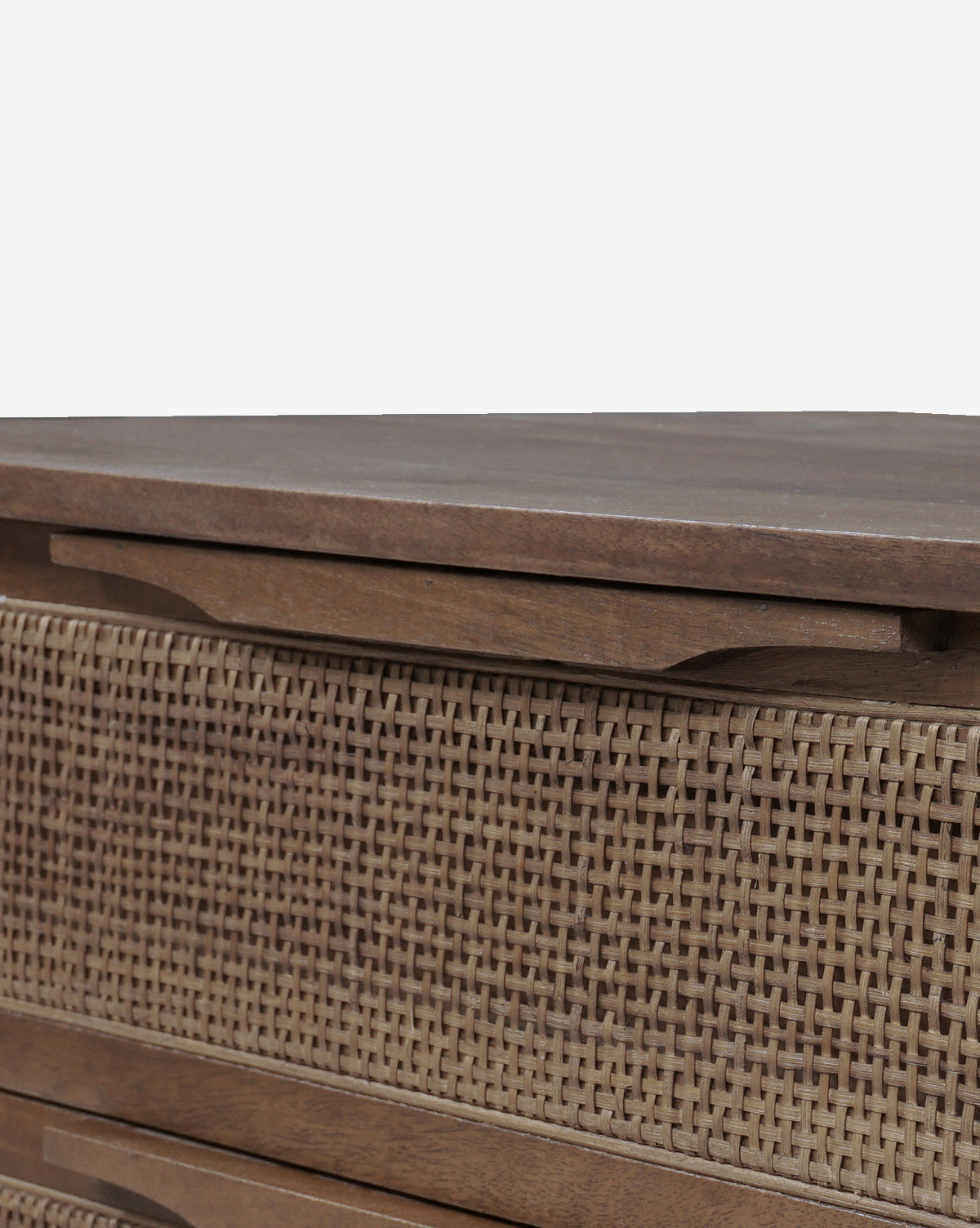 Close-up of the Margaery Nightstand, showcasing its woven cane design with rattan-front drawers and integrated wooden handles. The detailed shot emphasizes the rattan’s texture and pattern against the nightstand’s smooth wood finish, by McGee & Co.