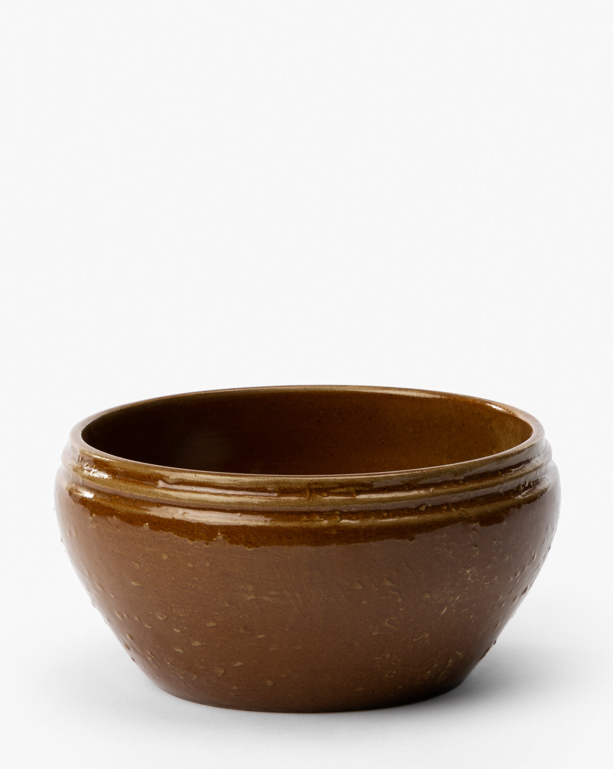 The Mariella Stoneware Bowls (Set of 4) feature a round, brown design with a glossy finish and subtle organic texture, gently curved rims, and a handmade quality—perfect for adding artisanal style to your table, by McGee & Co.