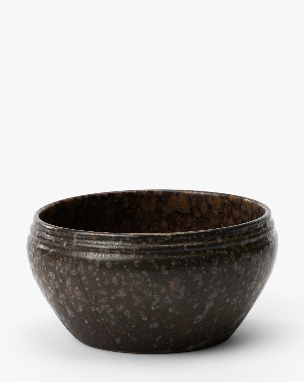 The Mariella Stoneware Bowls (Set of 4) feature a dark brown, speckled finish and slightly flared rims, highlighting their handmade quality against a plain white background, by McGee & Co.