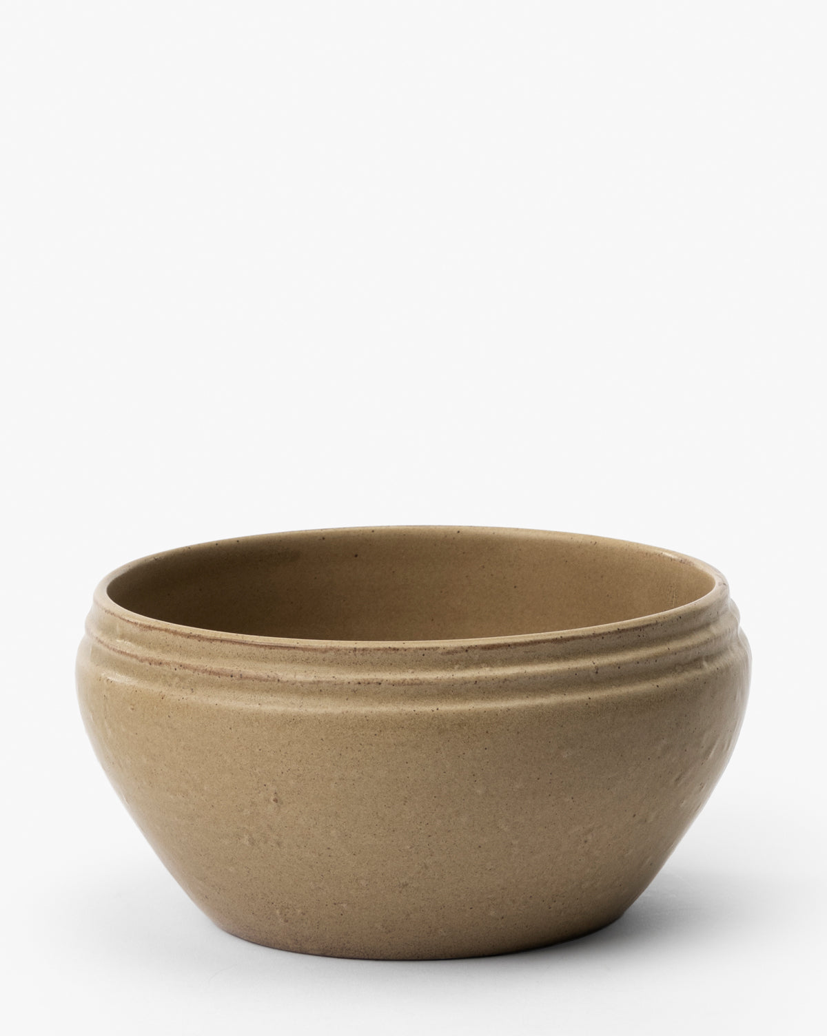 The Mariella Stoneware Bowls (Set of 4) feature a simple, round tan design with a slightly flared rim and subtle horizontal grooves near the top, highlighting handmade quality against a plain white background, by McGee & Co.