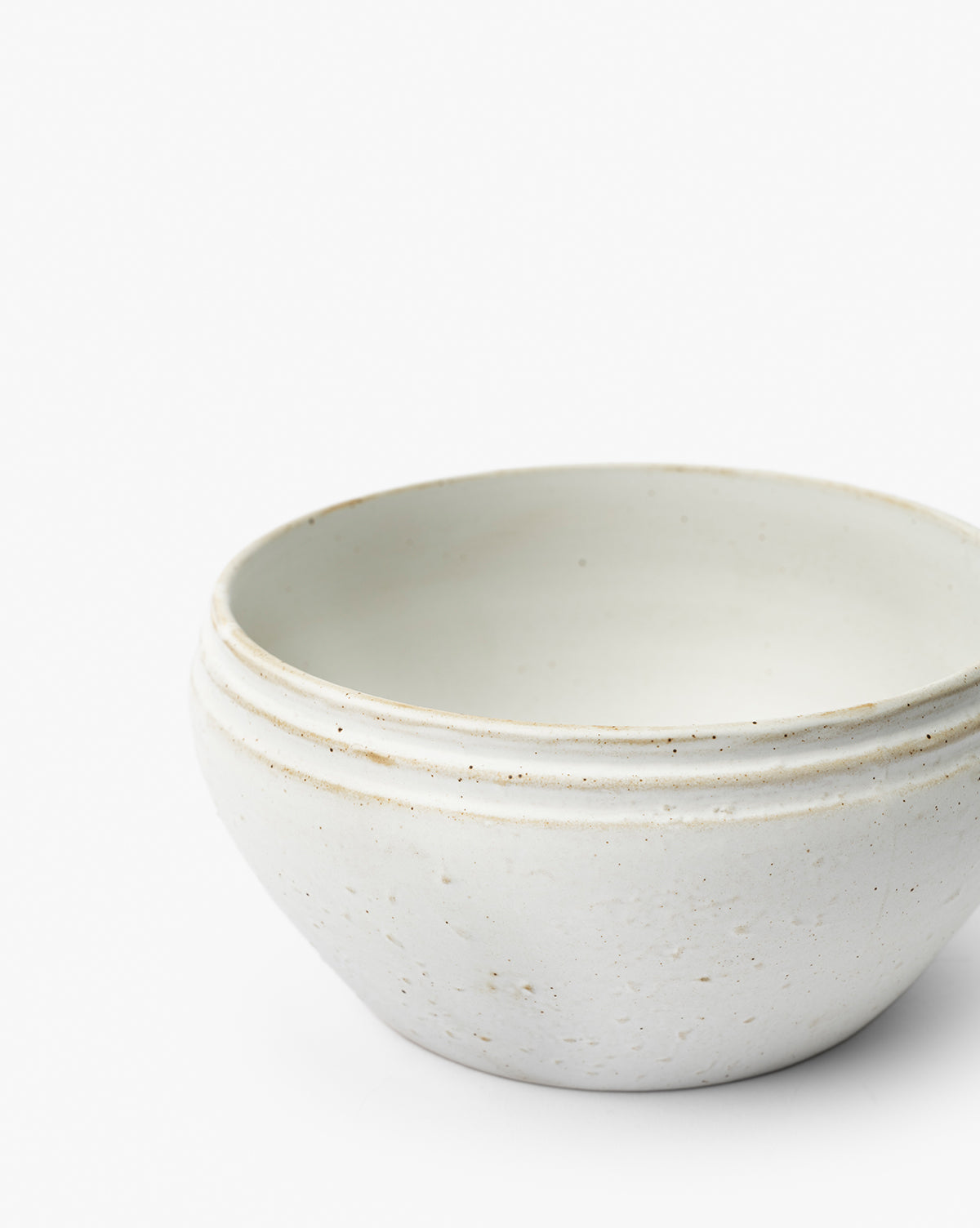 The Mariella Stoneware Bowls (Set of 4) feature a simple round shape, off-white finish with a subtly organic texture and speckles, plus three horizontal lines near the rim—all showcased against a plain white background, by McGee & Co.