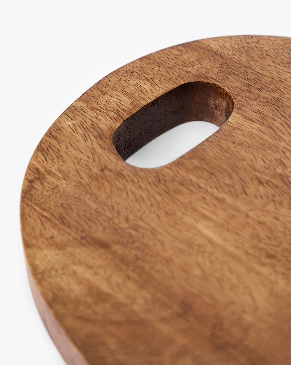 Close-up of the Marlton Breadboard, a round wooden serving board with a smooth surface and an oval cut-out handle, ideal for artisanal kitchen decor, shown against a white background by McGee & Co.