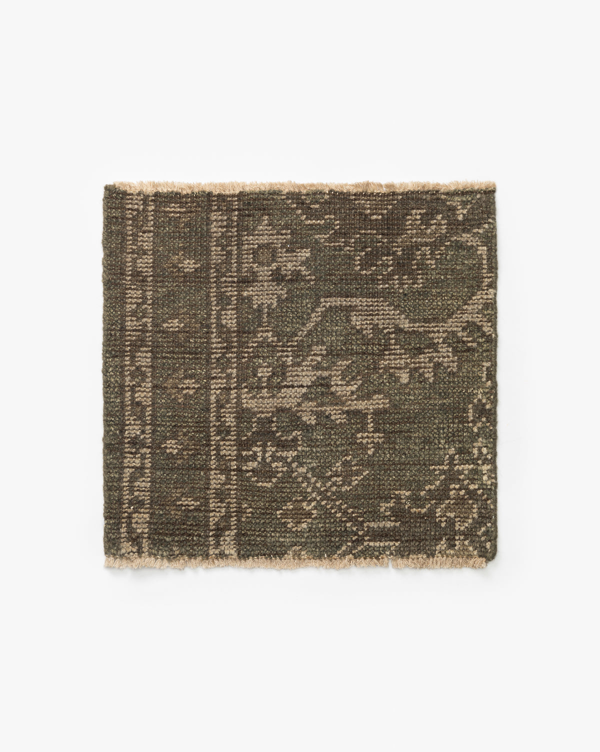 The Marola Hand-Knotted Rug Swatch features a rectangular design in dark olive green and beige wool, with a subtle intricate pattern and one fringed edge, shown against a white background by McGee & Co.
