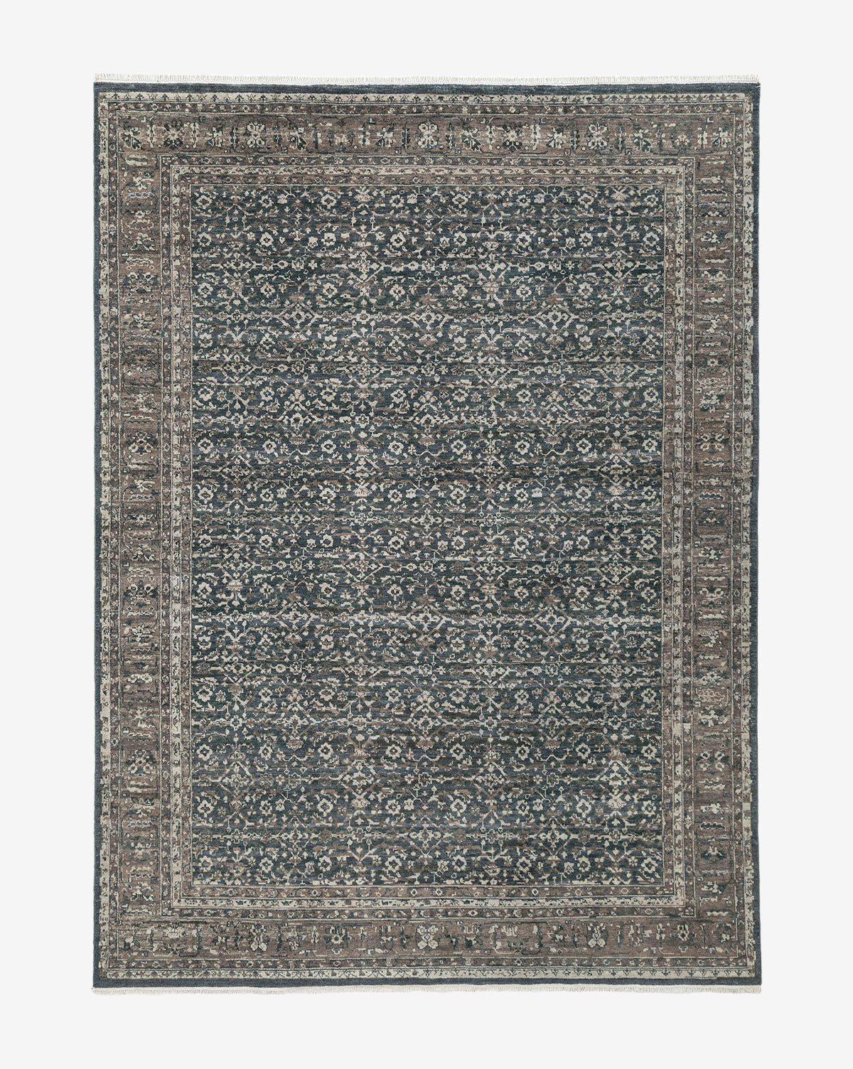 The Marta Hand-Knotted Wool Rug is a rectangular wool rug featuring an intricate, symmetrical pattern in muted blue, beige, and grey with a detailed border and densely patterned central field, by McGee & Co.